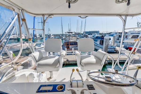 Cockpit view of 1999 Viking 47 Convertible yacht docked at marina.