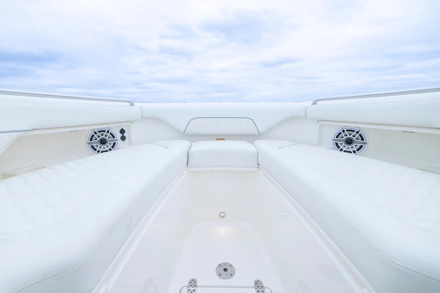Manufacturer Provided Image: 2026 Pursuit DC 286 Dual Console boat interior with white seating and speakers.