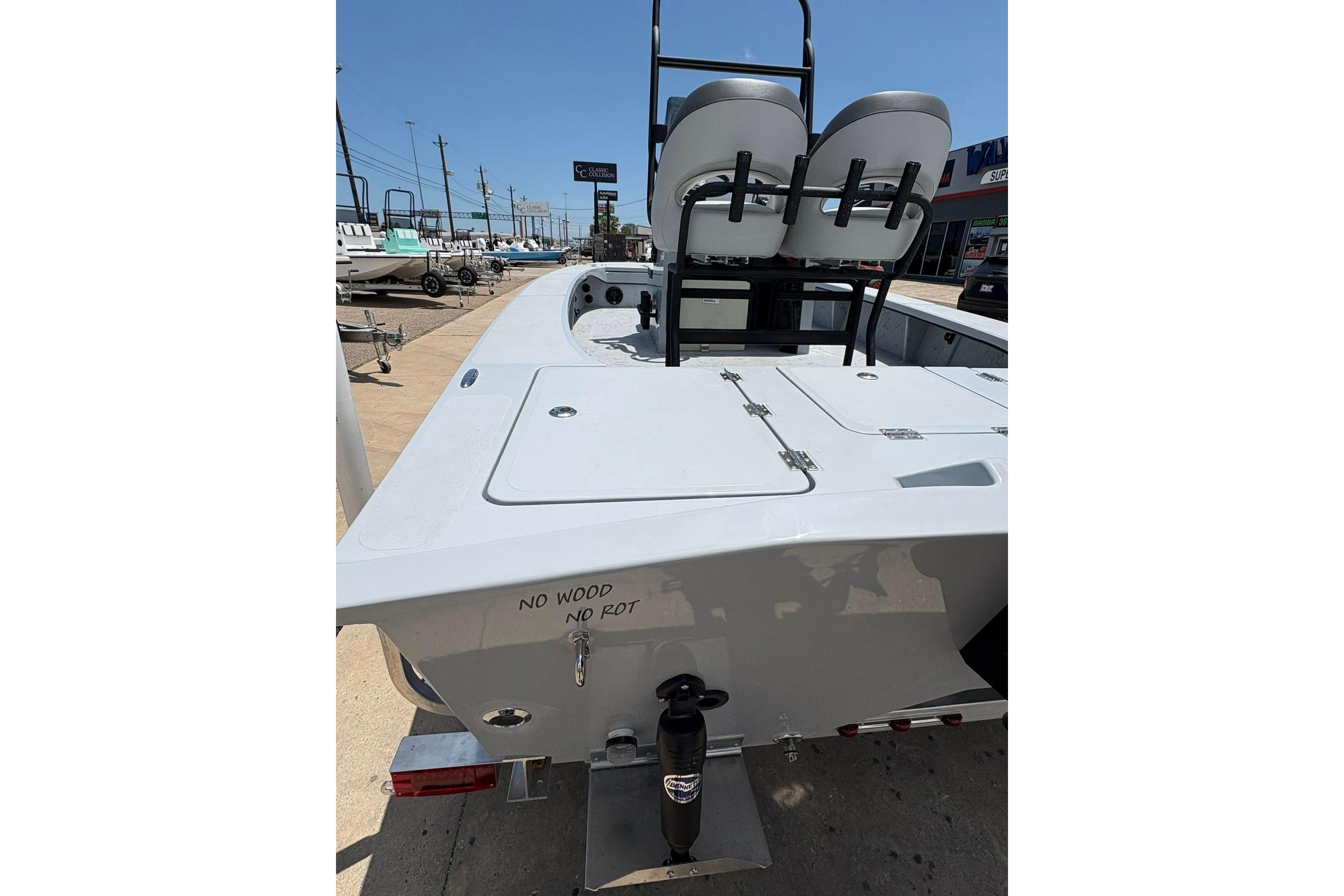 2026 Freedom Boats 23' Warrior, rear view, showcasing seating and storage compartments.
