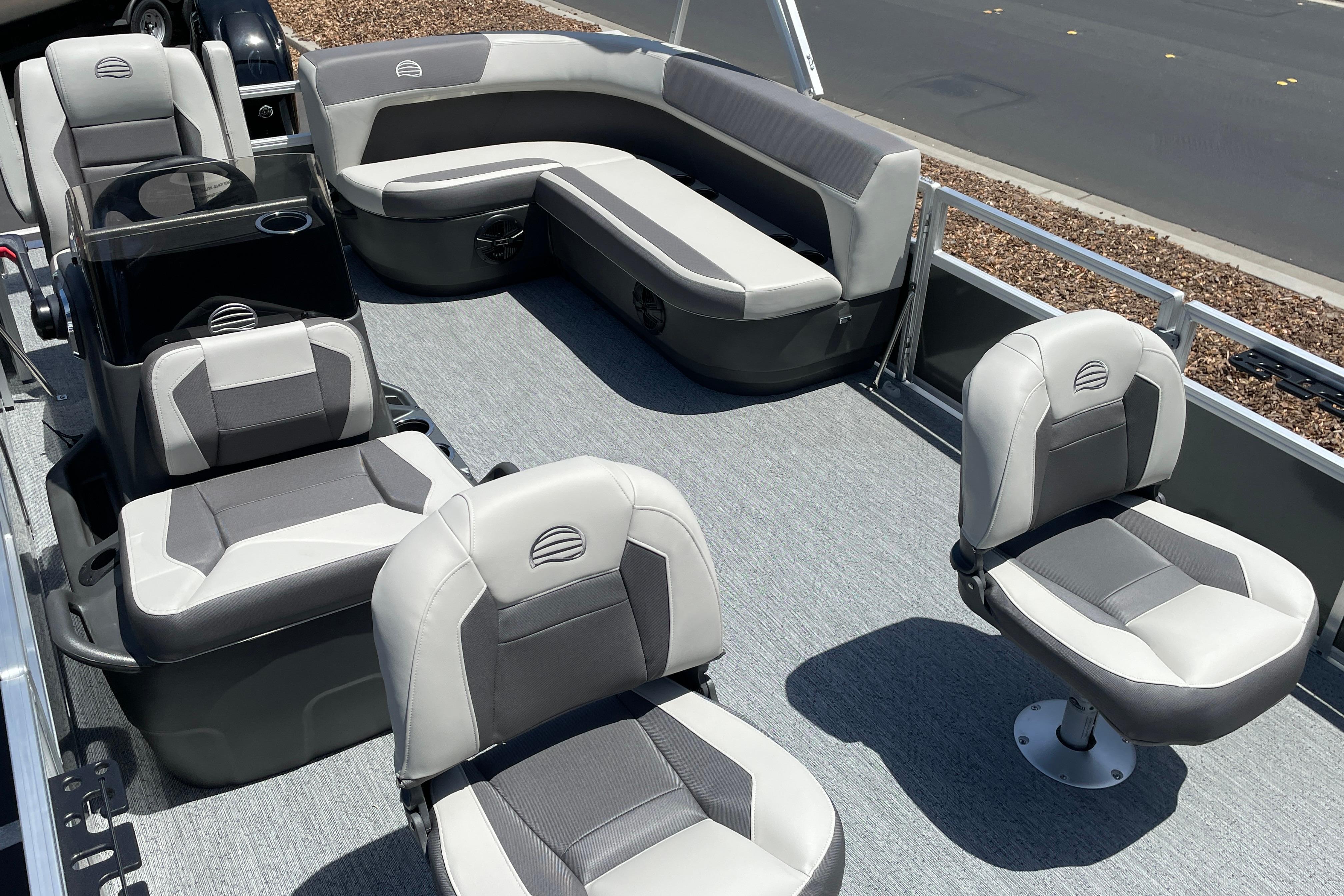 2026 Sun Tracker Bass Buggy 16 XL Select pontoon boat interior with gray seating and carpet.