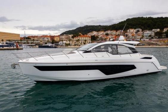 2019 Azimut Atlantis 51 yacht docked in a scenic harbor setting.