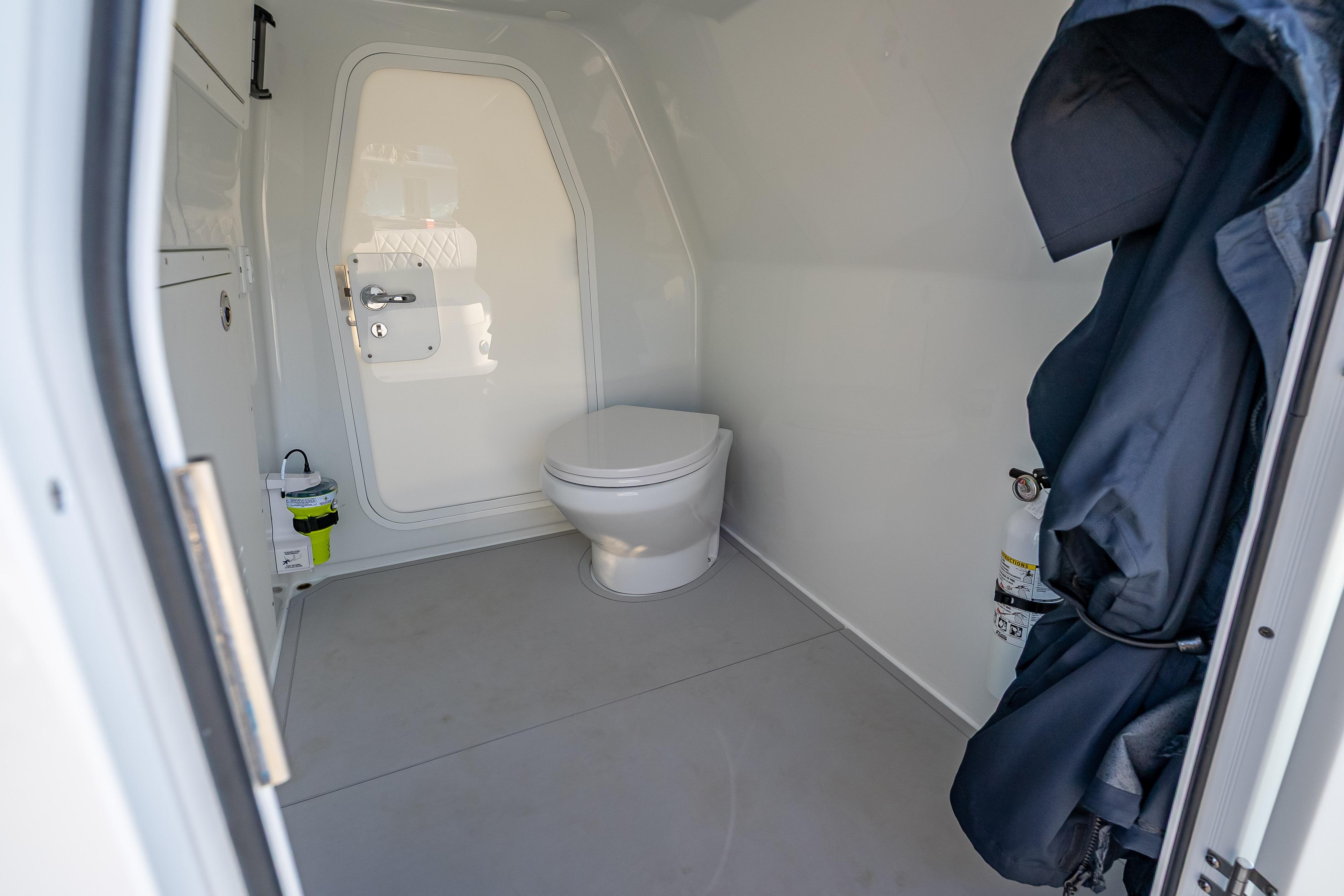 Modern bathroom interior in Freeman 35, 2026 model, featuring a sleek toilet and minimalistic design.