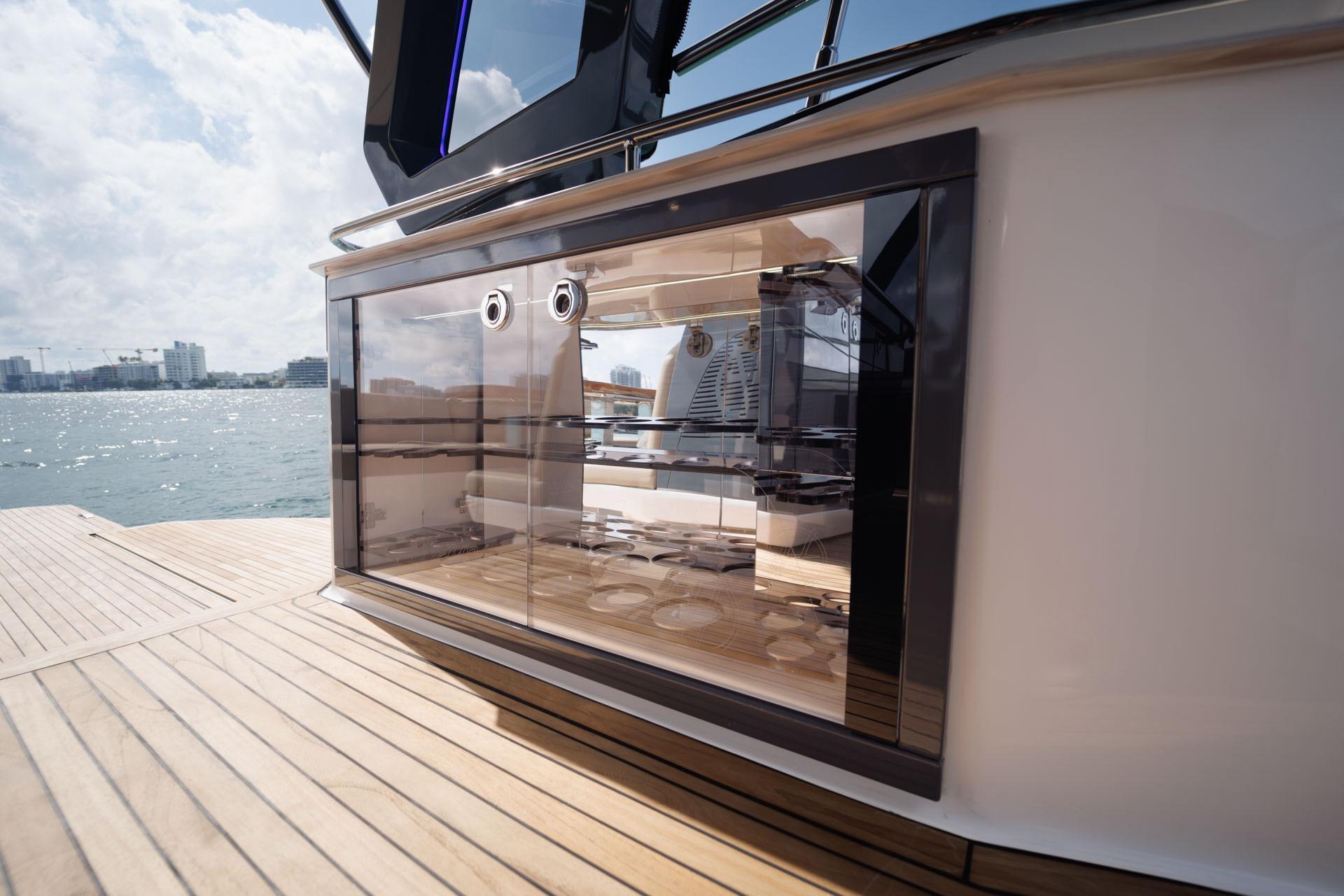 Luxury yacht Hanover 447 (2026) with sleek glass cabinetry, docked by the waterfront.
