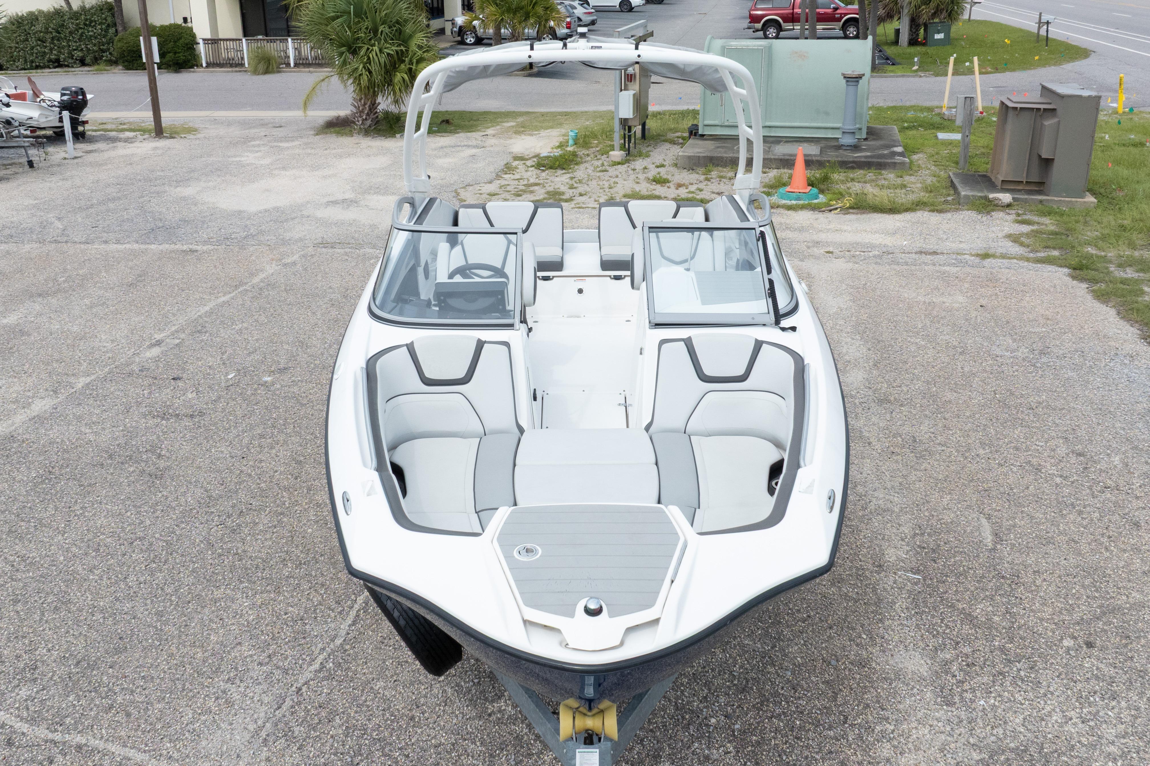 2021 Yamaha Boats AR250, white and gray interior, parked on concrete surface.
