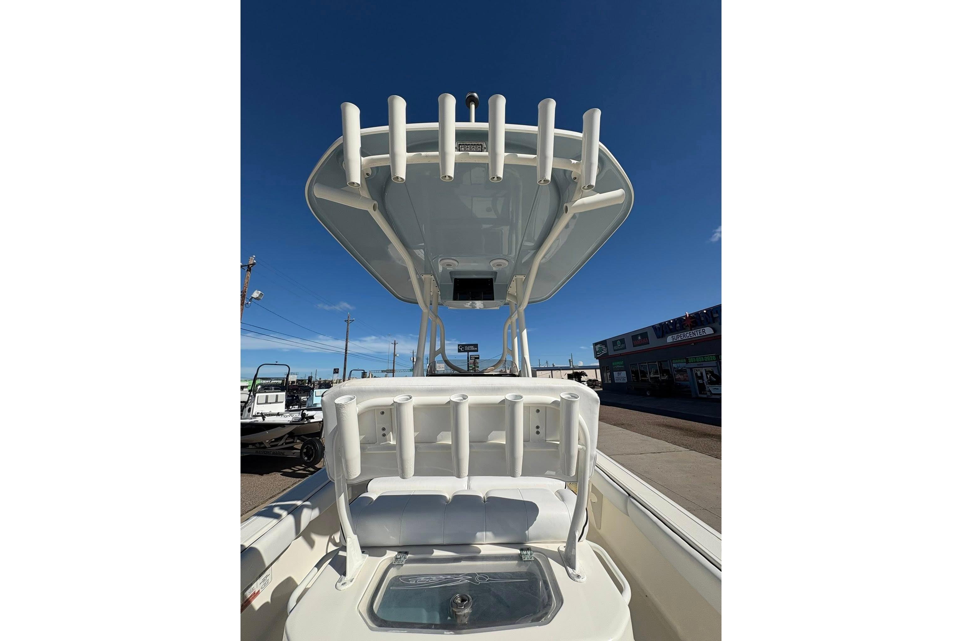 2023 Skeeter SX2550 Family boat with rod holders and seating, under clear blue sky.