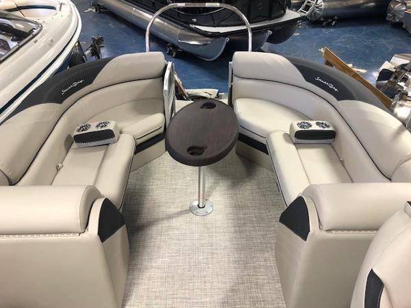 2023 South Bay 224RS LE 2.75 boat interior with beige seating and central table.