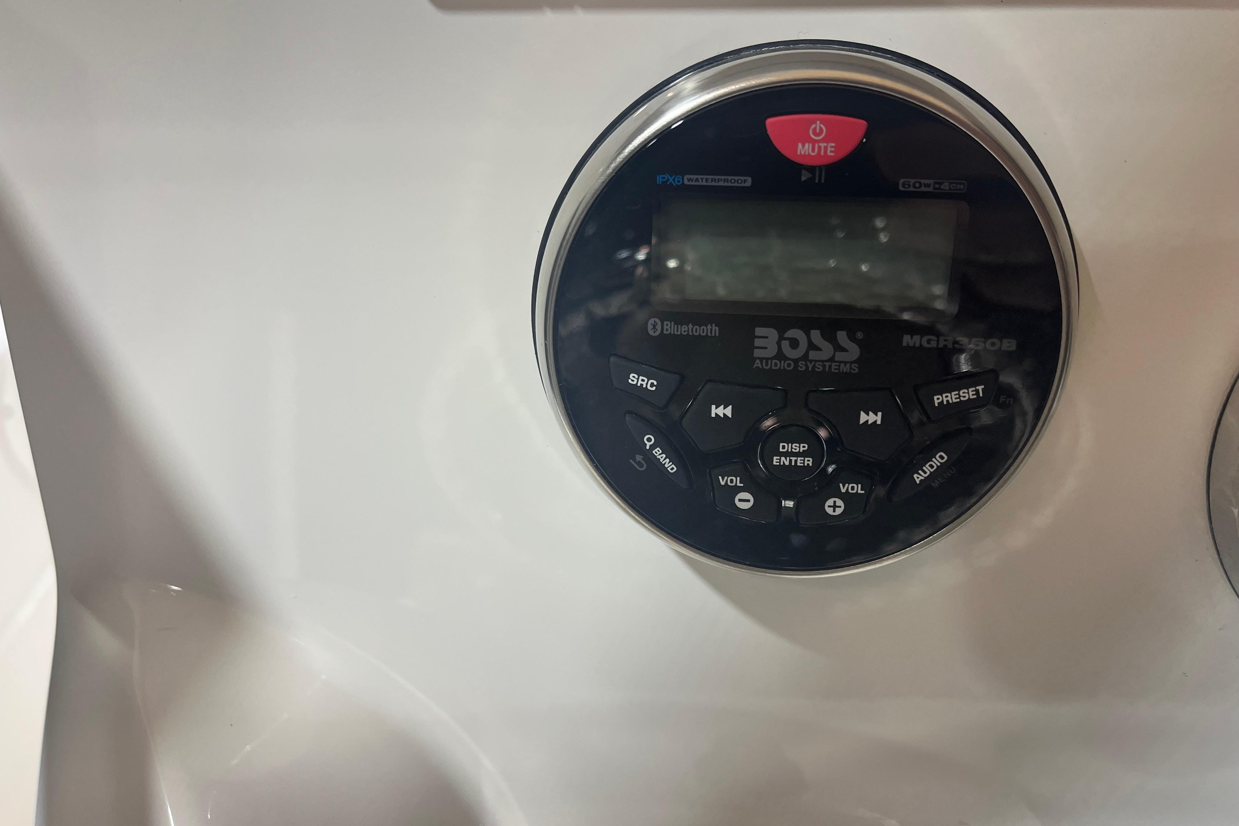 BOSS audio system on 2023 NauticStar 227 XTS boat dashboard, featuring Bluetooth and waterproof design.