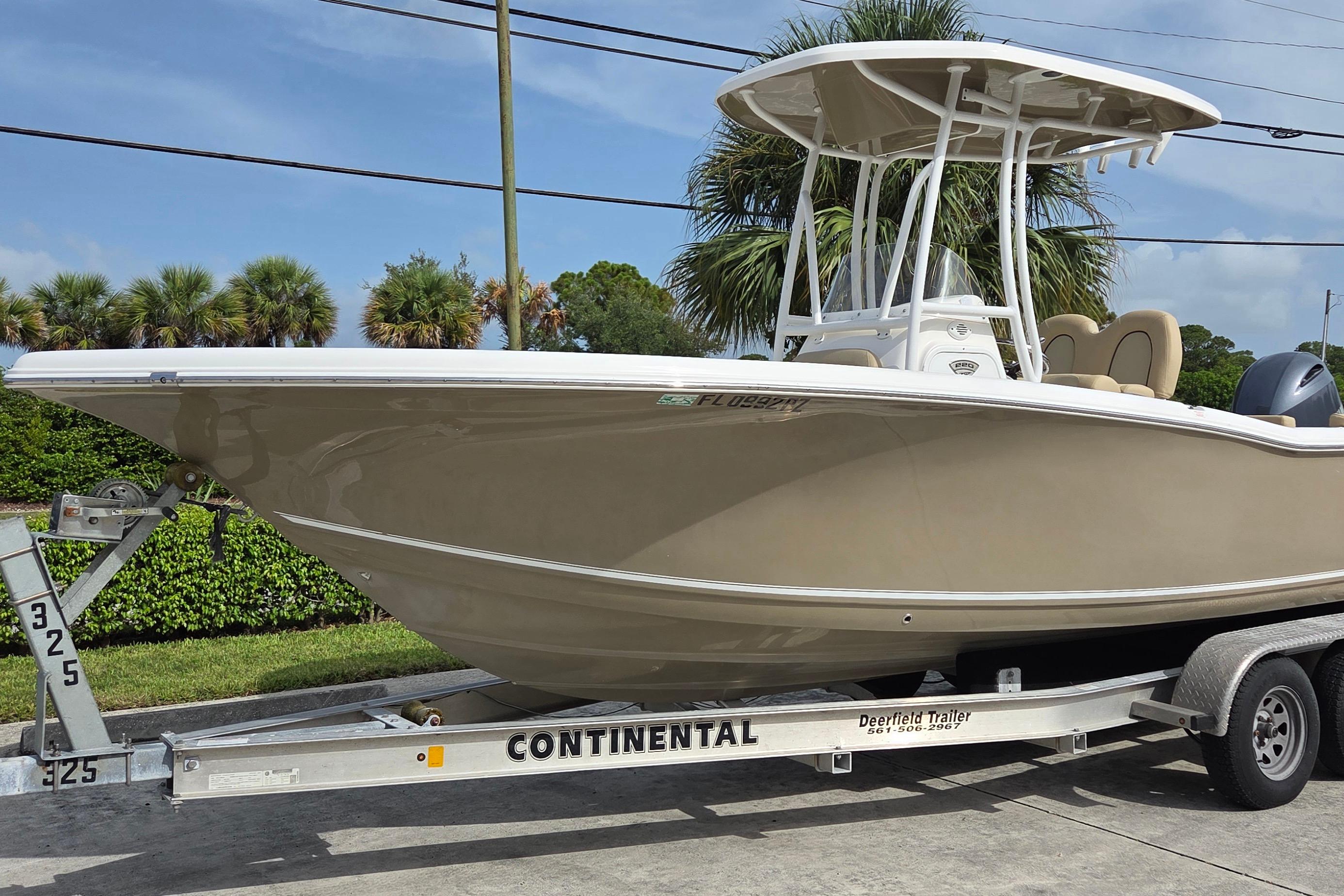 2015 Tidewater 220 LXF boat on Continental trailer, parked outdoors.