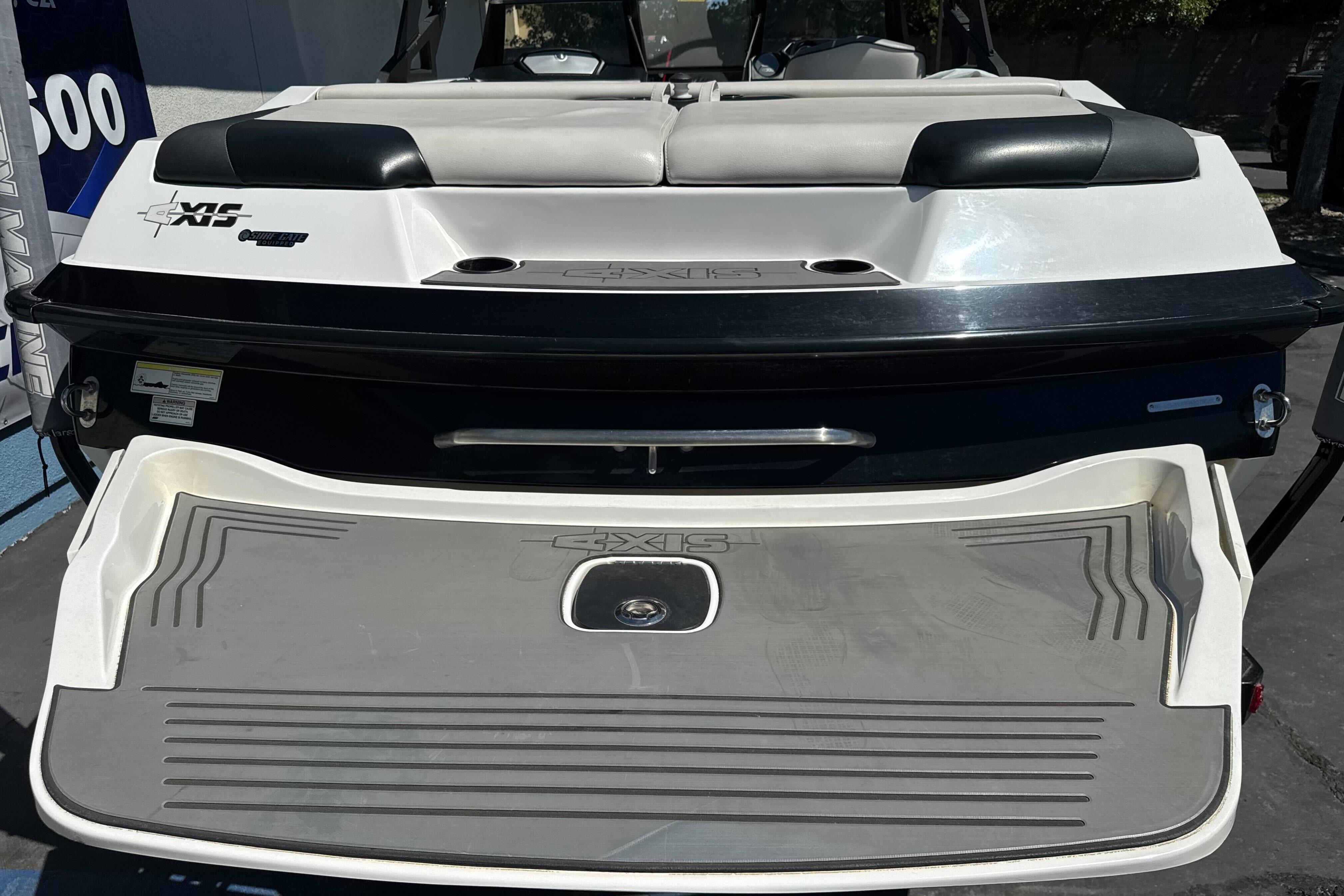 2015 Axis A20 boat rear view with swim platform and seating area.
