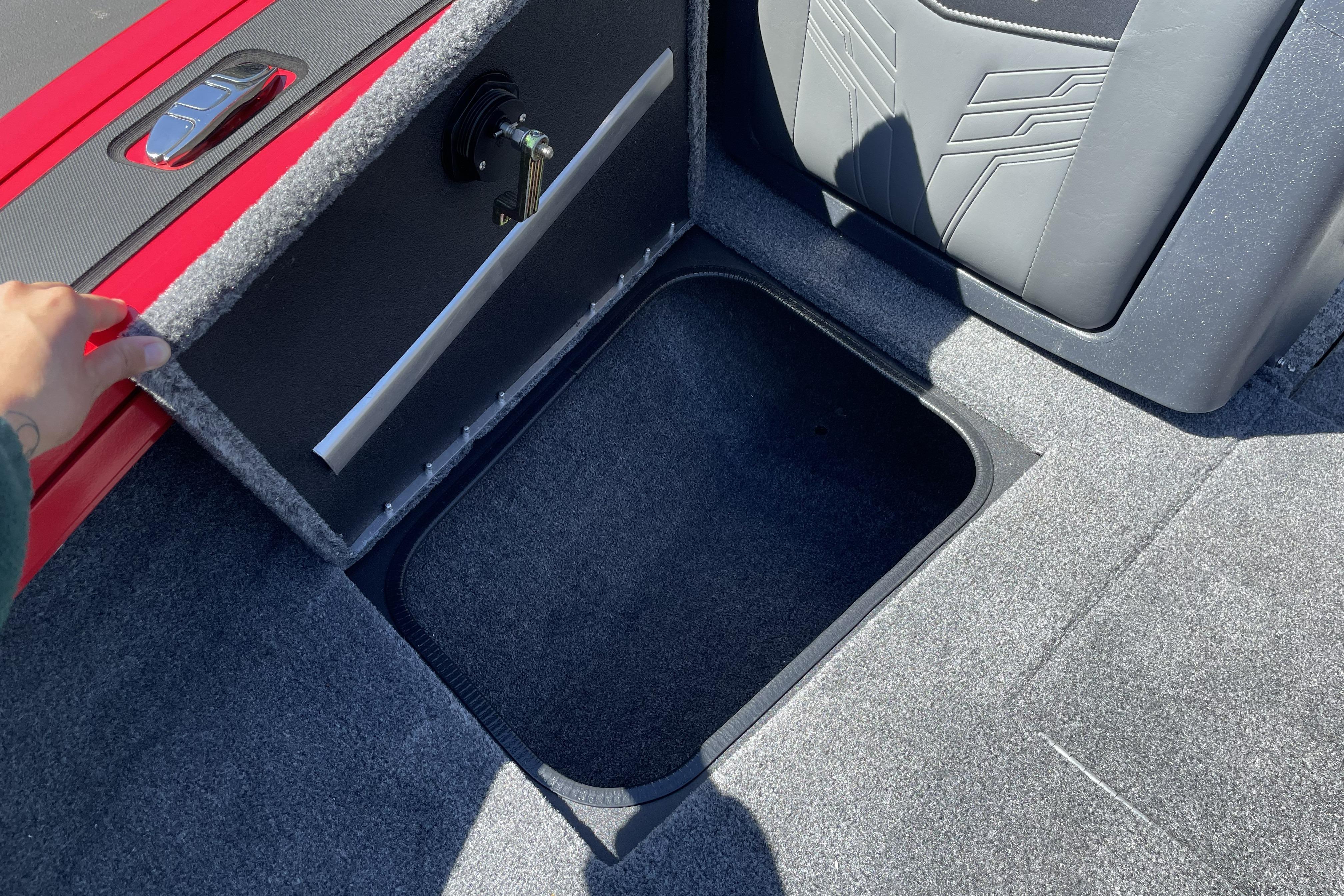 2026 Tracker Targa V-18 WT boat storage compartment with open lid and gray interior.