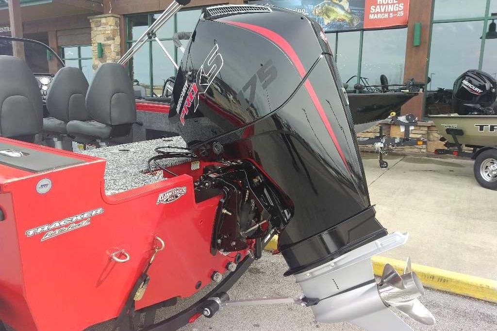 2026 Tracker Targa V-18 WT boat with powerful outboard motor, parked outdoors.