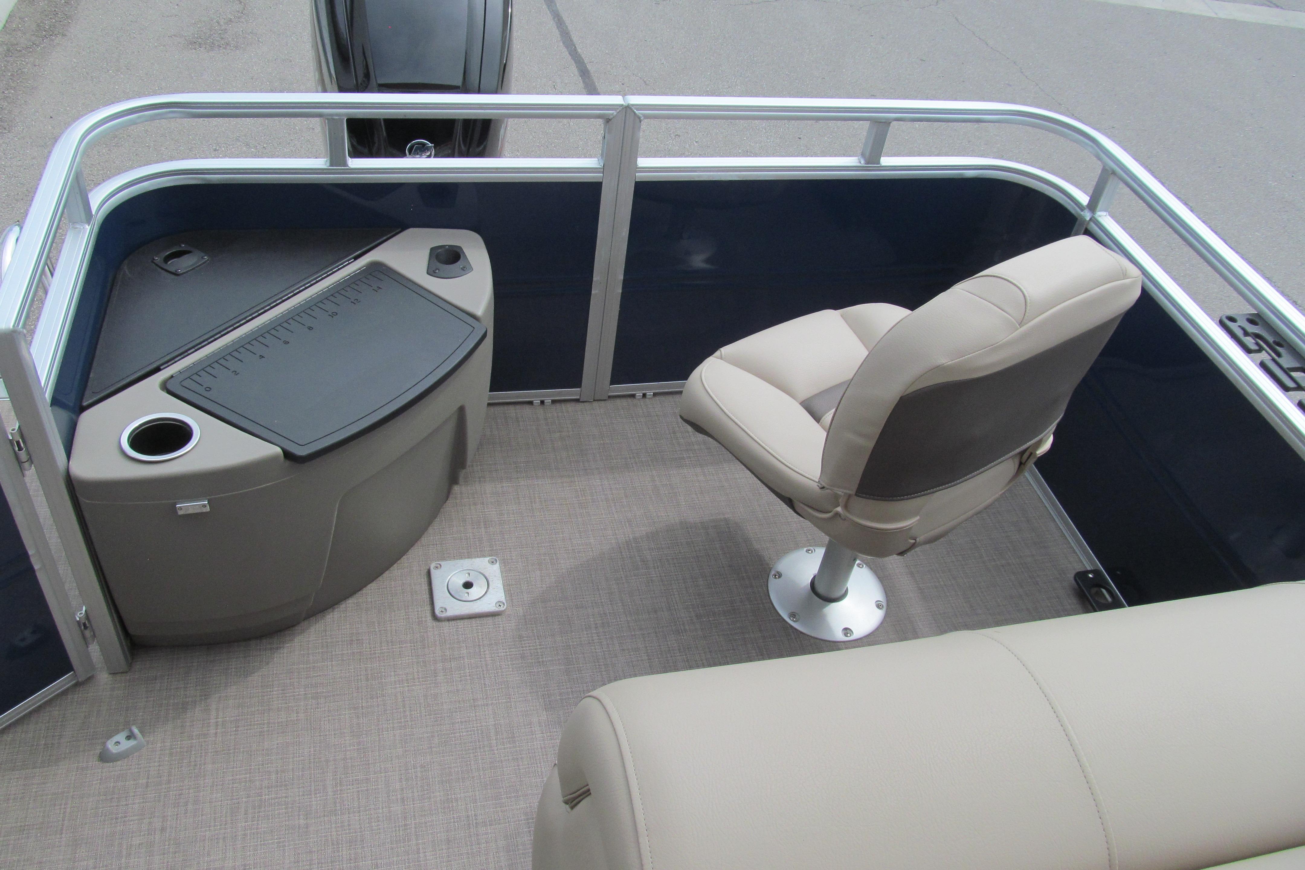 2024 Sun Tracker Fishin' Barge 20 DLX interior with seating and storage area.