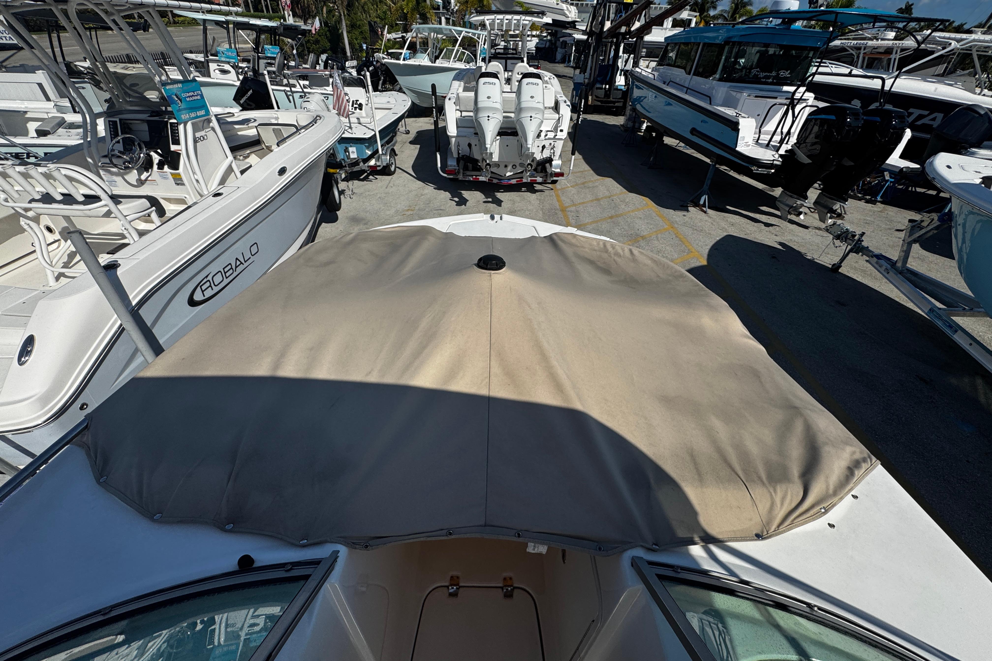 2021 Hurricane SunDeck 2200 DC OB boat with covered bow, surrounded by other boats.