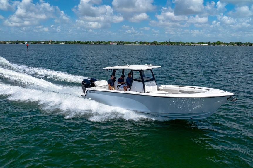 2027 Reef Runner 340 boat cruising on open water under a partly cloudy sky.