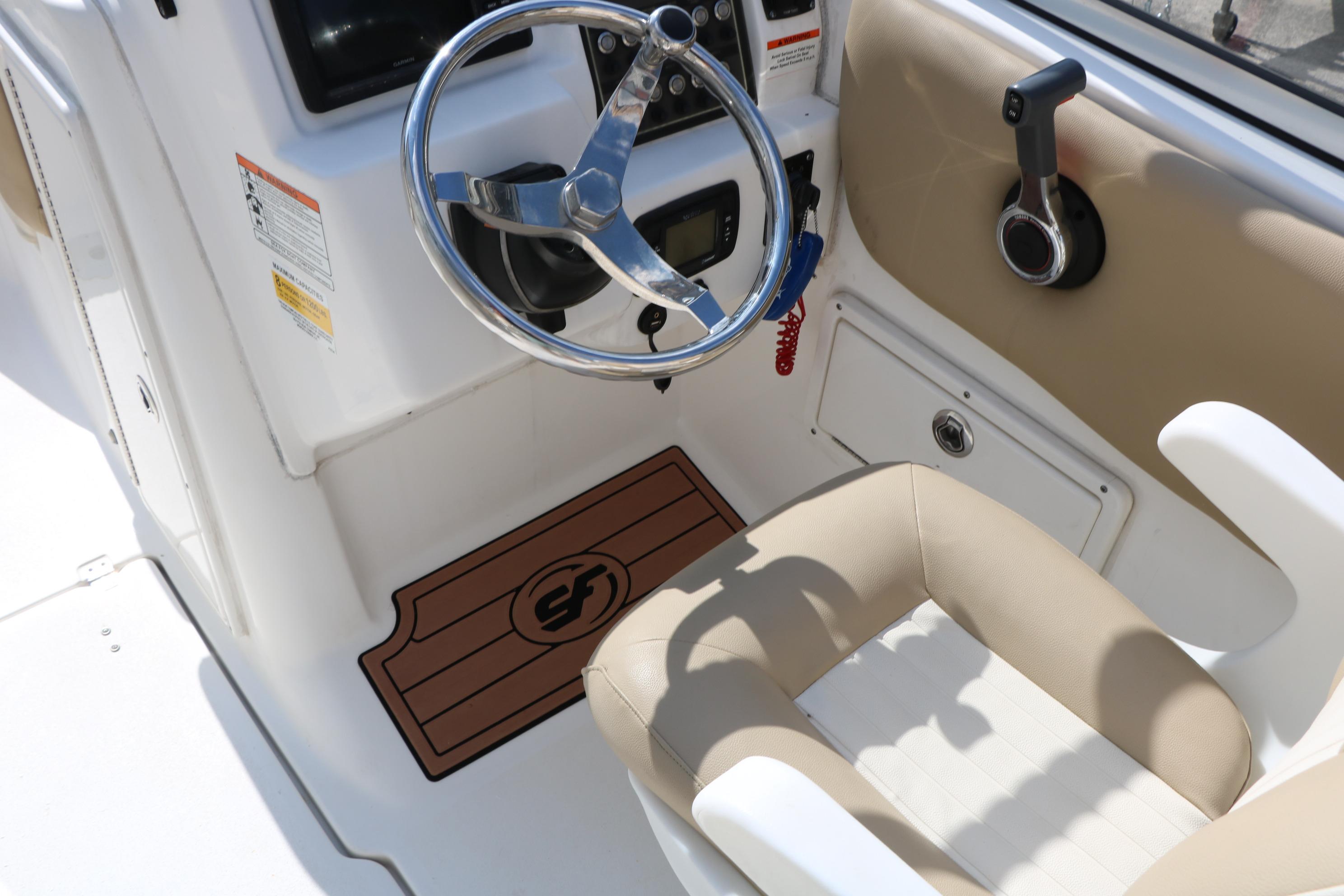Interior of 2017 Sea Fox 226 Traveler boat, featuring steering wheel and controls.