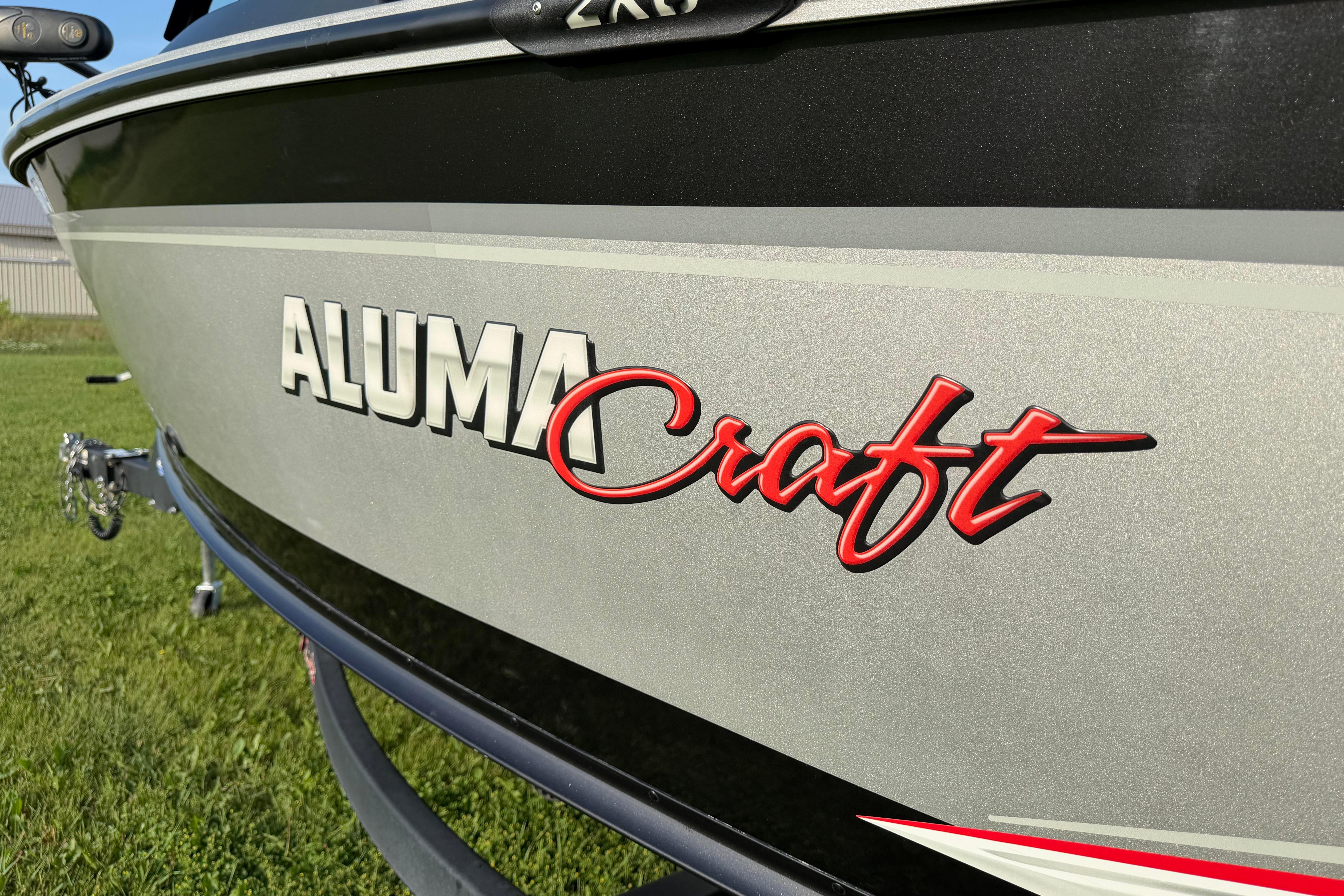 2019 Alumacraft Trophy 205 boat, close-up of logo on metallic hull.