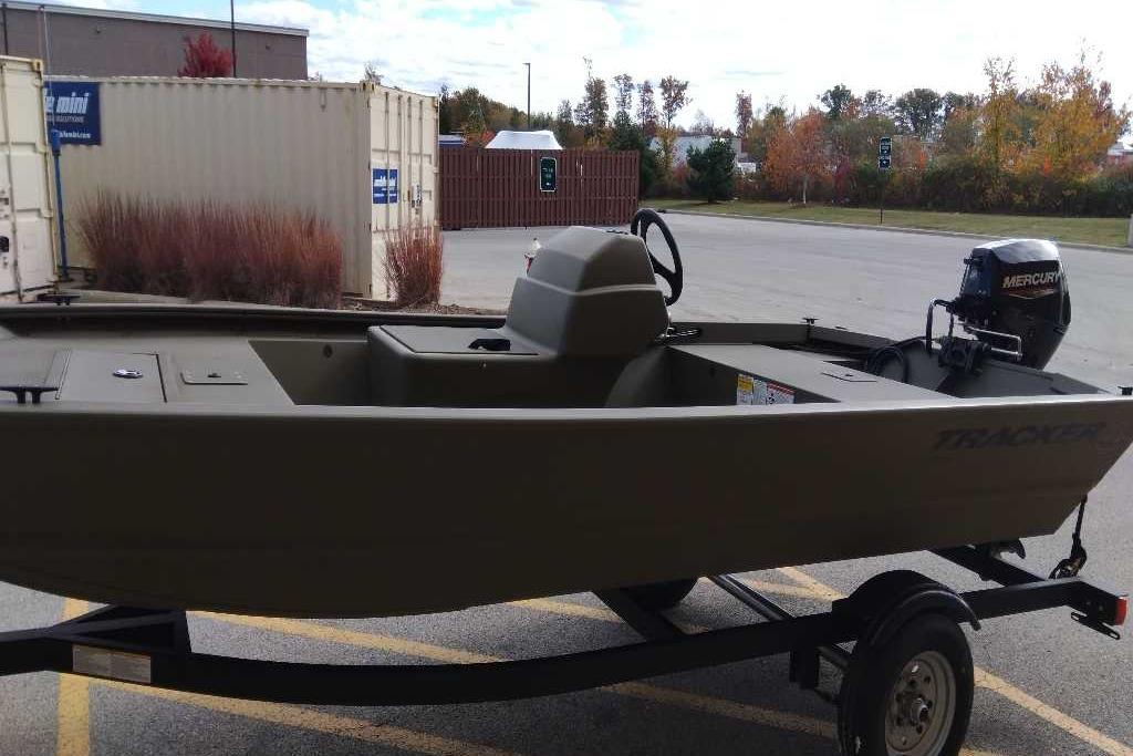 2026 Tracker Grizzly 1648 SC boat on trailer, parked outdoors.
