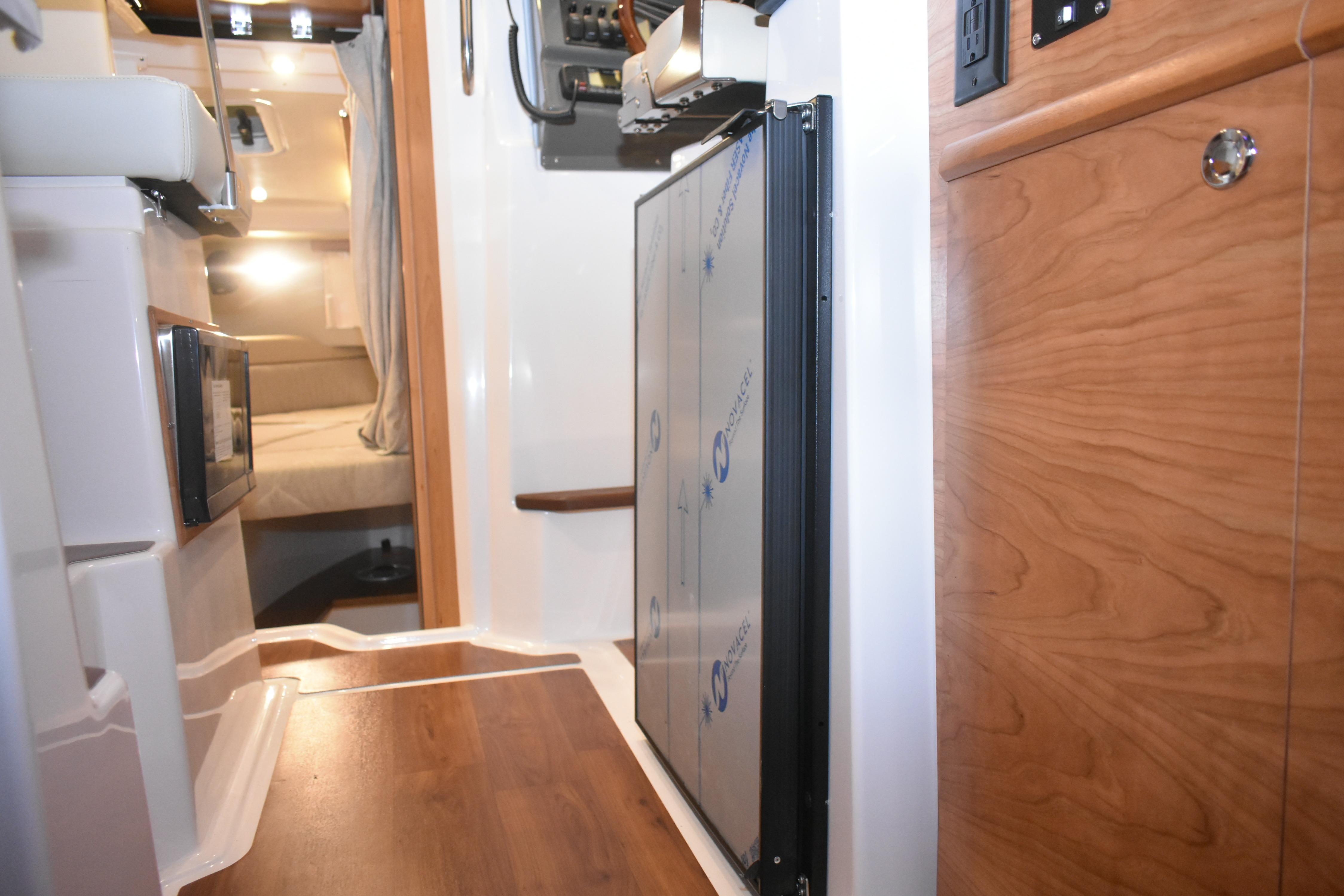 Interior of 2026 Cutwater C-248 Coupe, featuring wood accents and modern amenities.