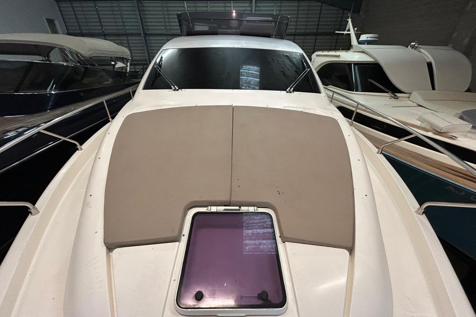2012 Ferretti 530 yacht in storage, showcasing sleek design and spacious deck.