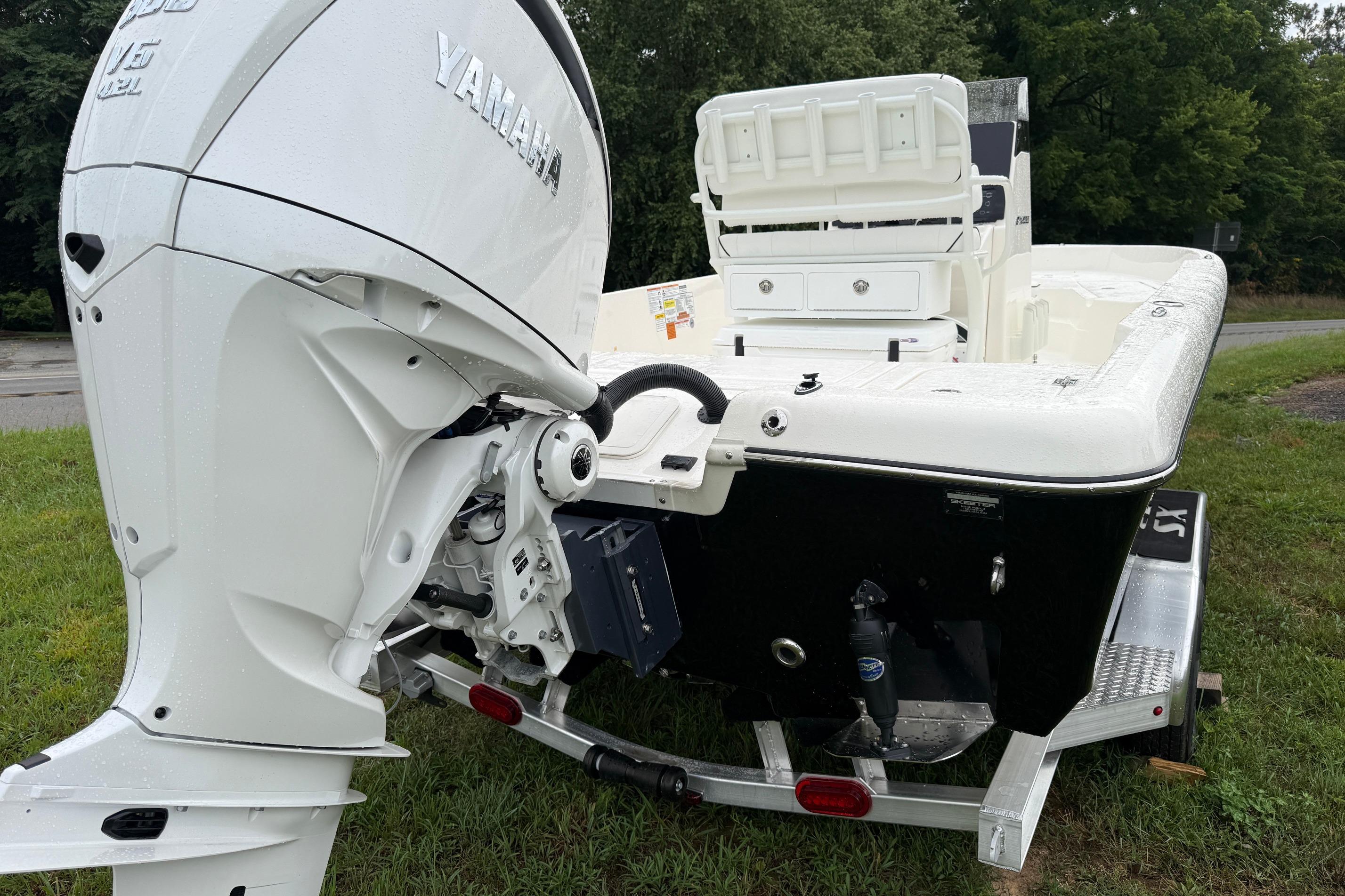 2026 Skeeter SX2350 boat with Yamaha outboard motor on a trailer, parked on grass.