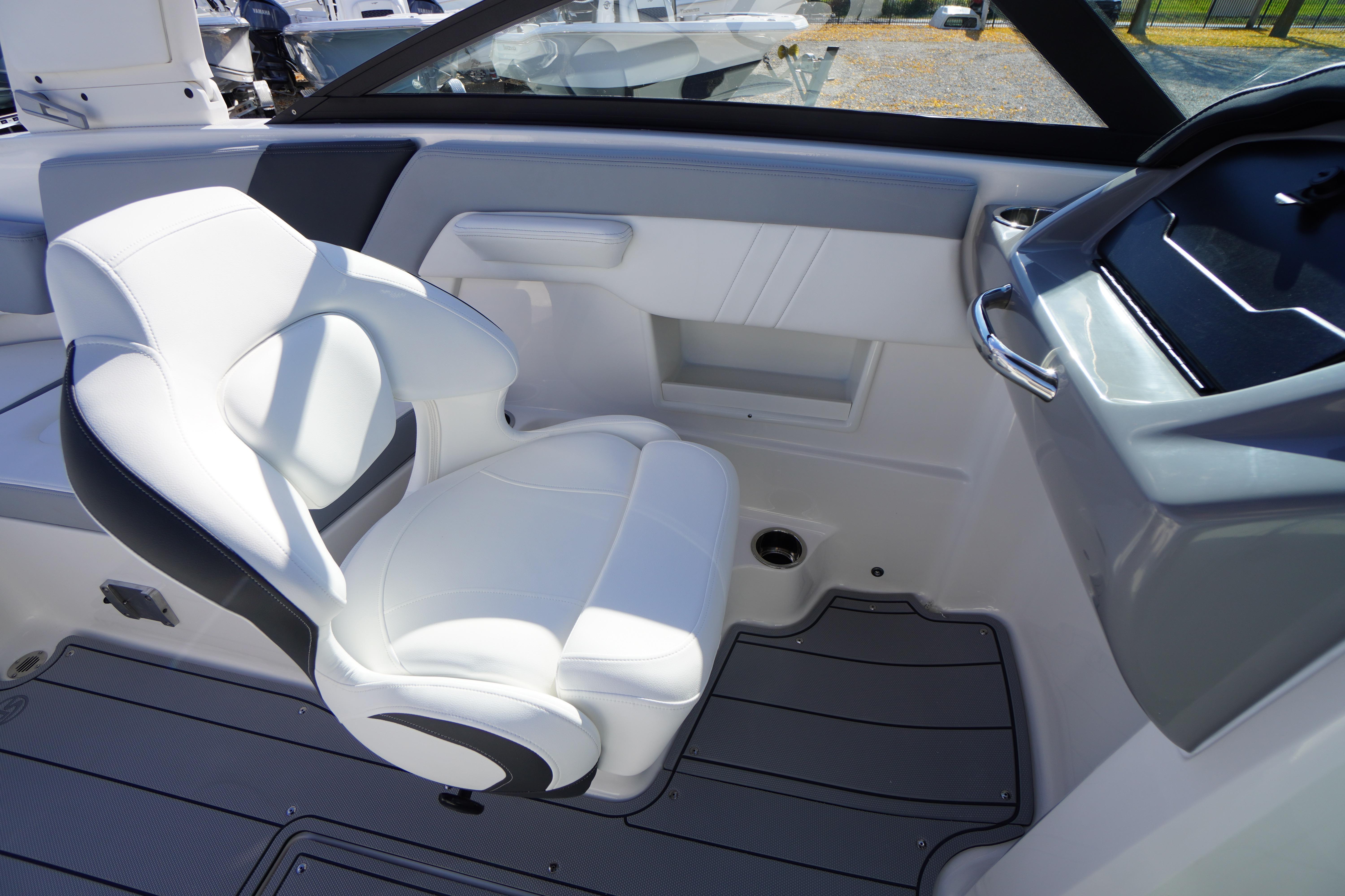 2026 Chaparral 23 SSi OB boat interior with white seating and modern dashboard.
