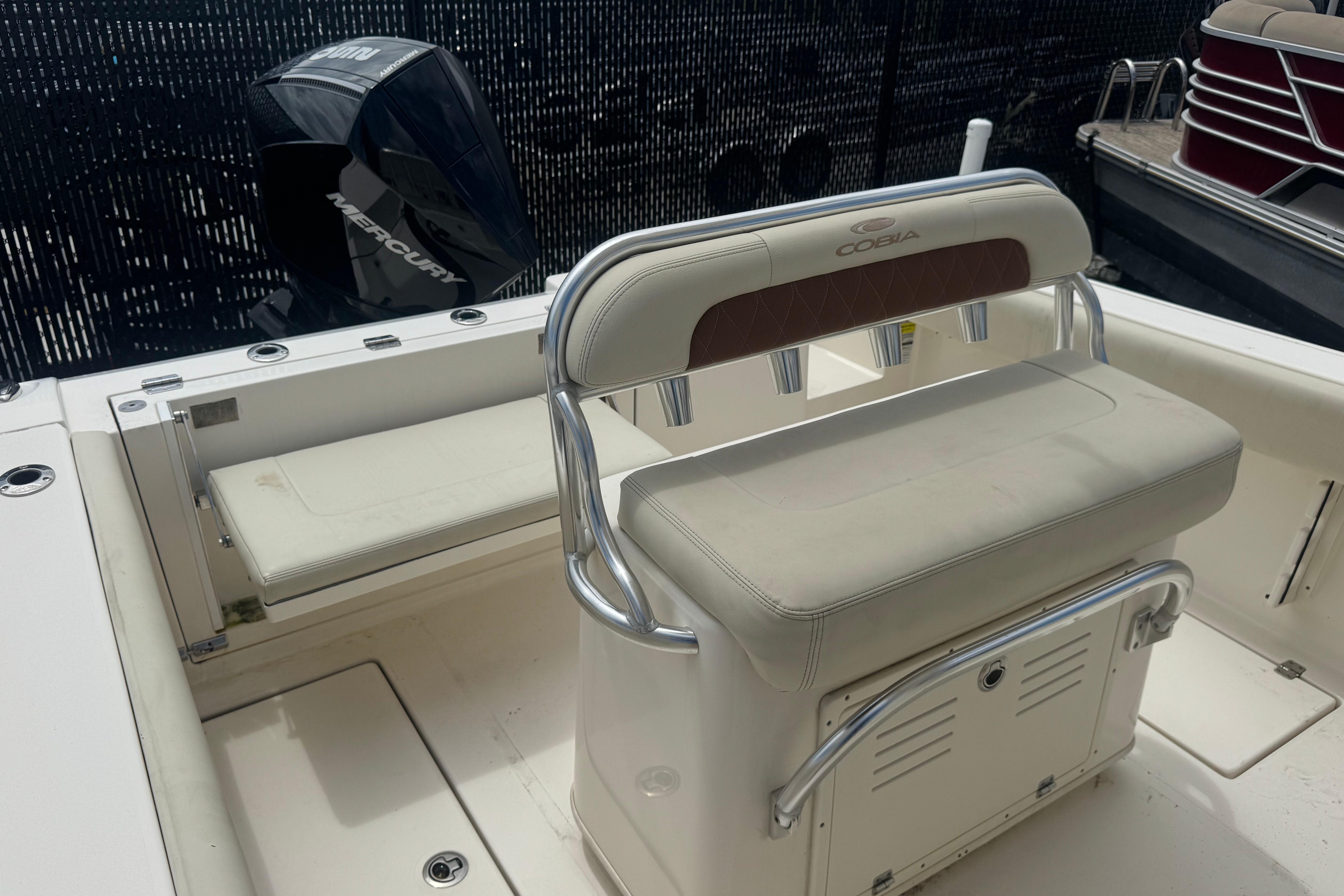 2022 Cobia 237 Center Console boat interior with seating and Mercury engine.