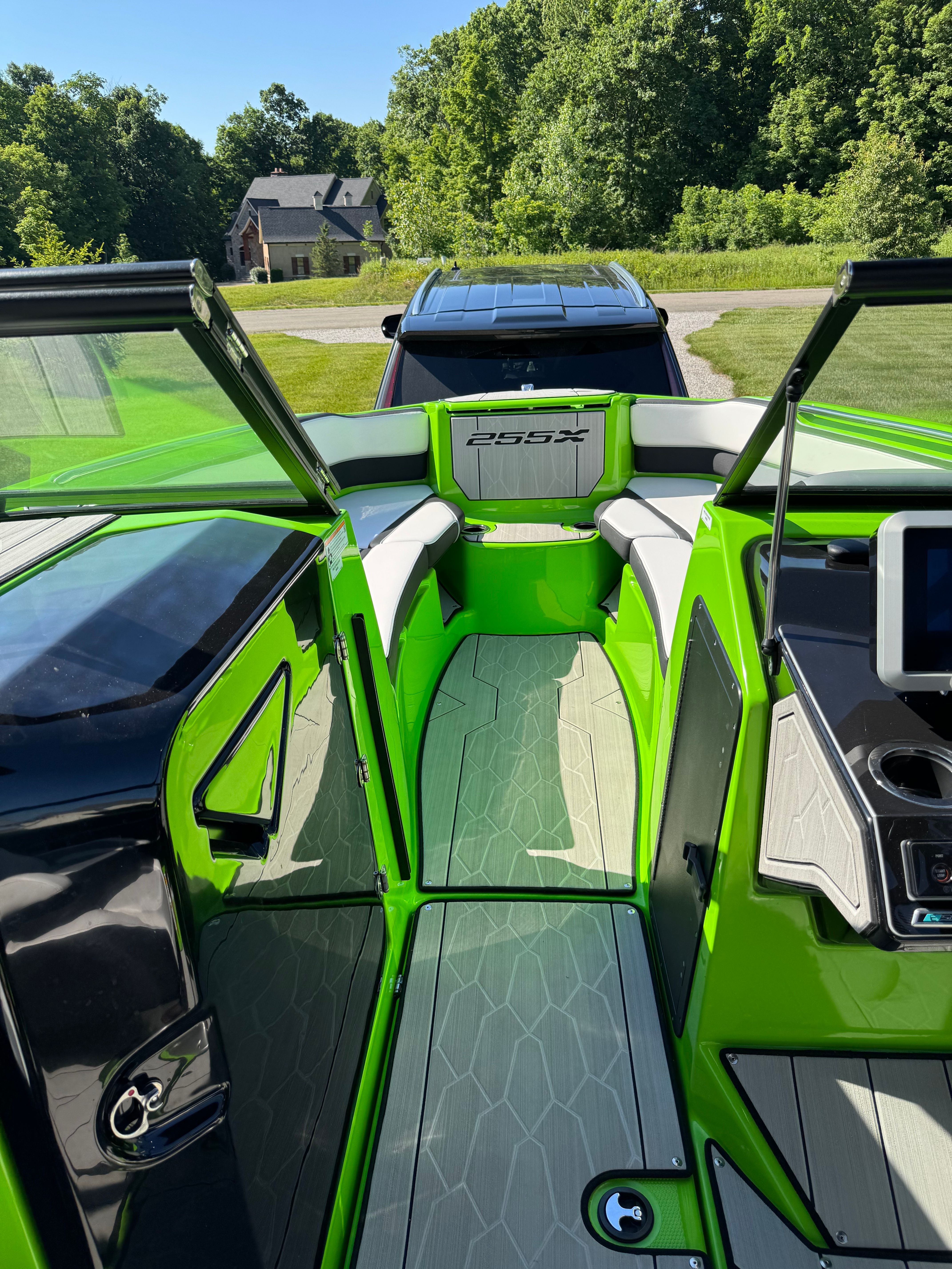 Green interior of a 2022 Yamaha 255XD boat, featuring modern seating and a screen.