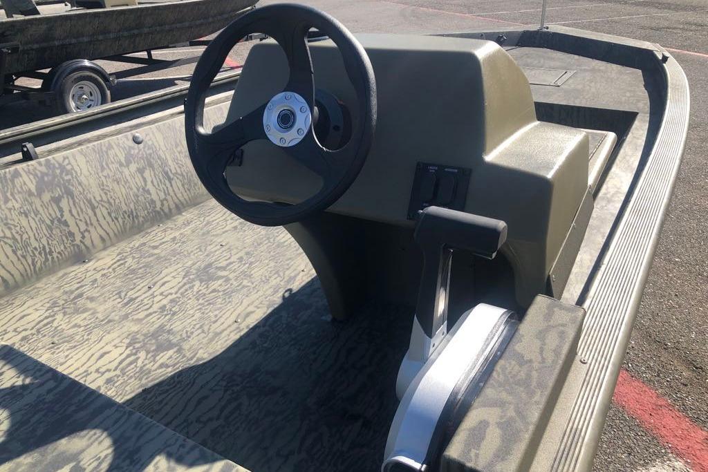 2026 Tracker Grizzly 1648 SC boat interior with steering wheel and control panel.