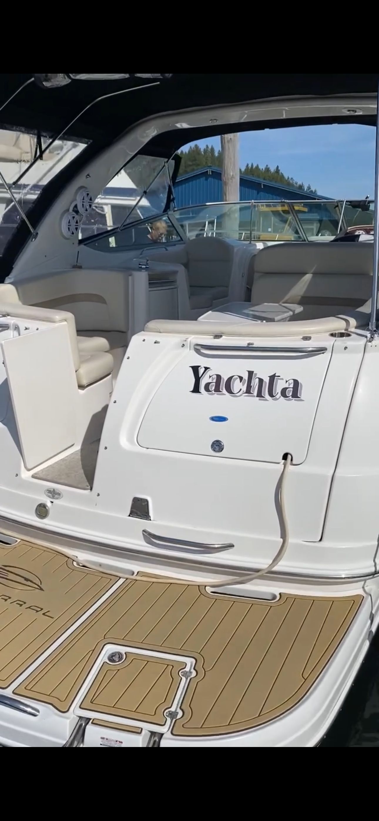 The image shows the stern of a 2004 Chaparral Signature 330 with an open cockpit area.
