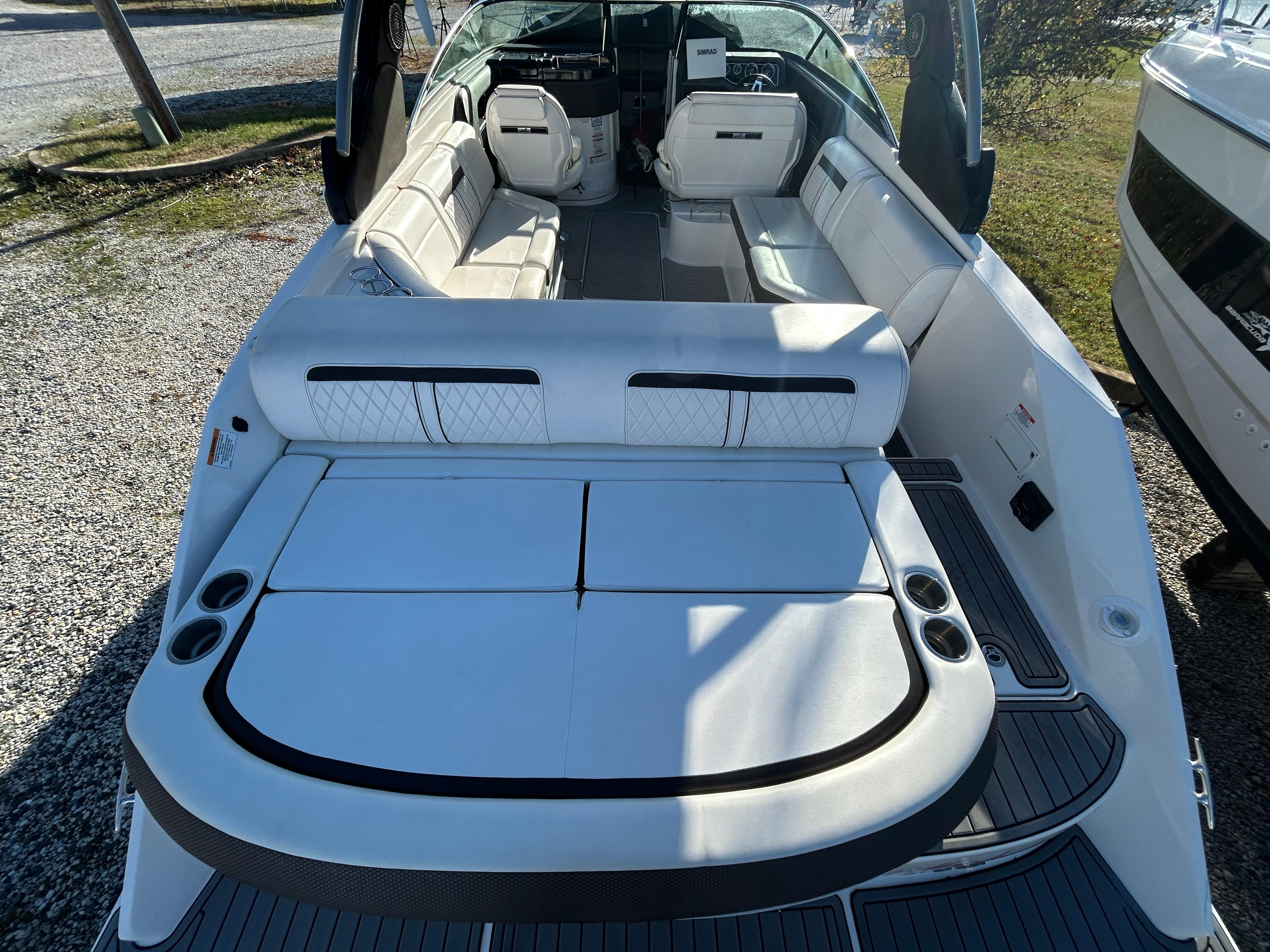 2018 Sea Ray SLX 280 boat interior with white seating and cup holders.
