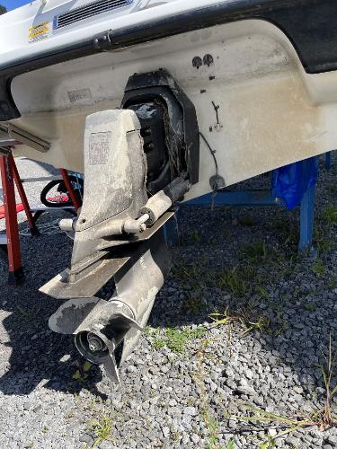 2005 Crownline 180 BR boat stern drive on gravel surface.