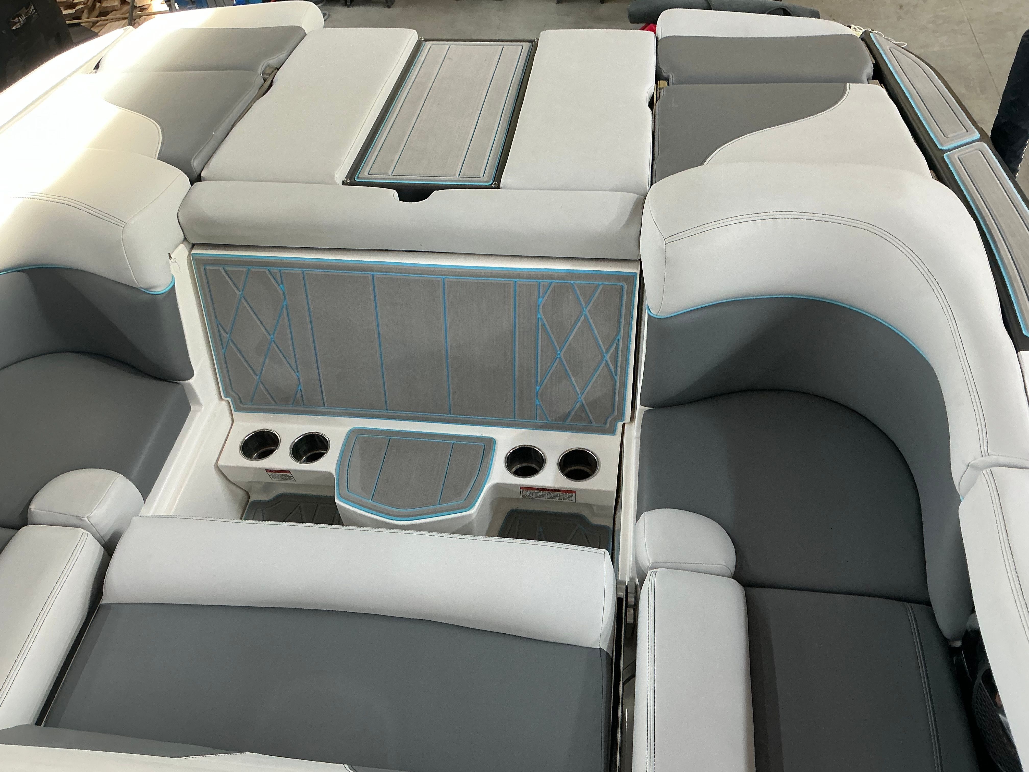The image shows the interior of a 2019 MasterCraft XT22 boat with gray and white seating.