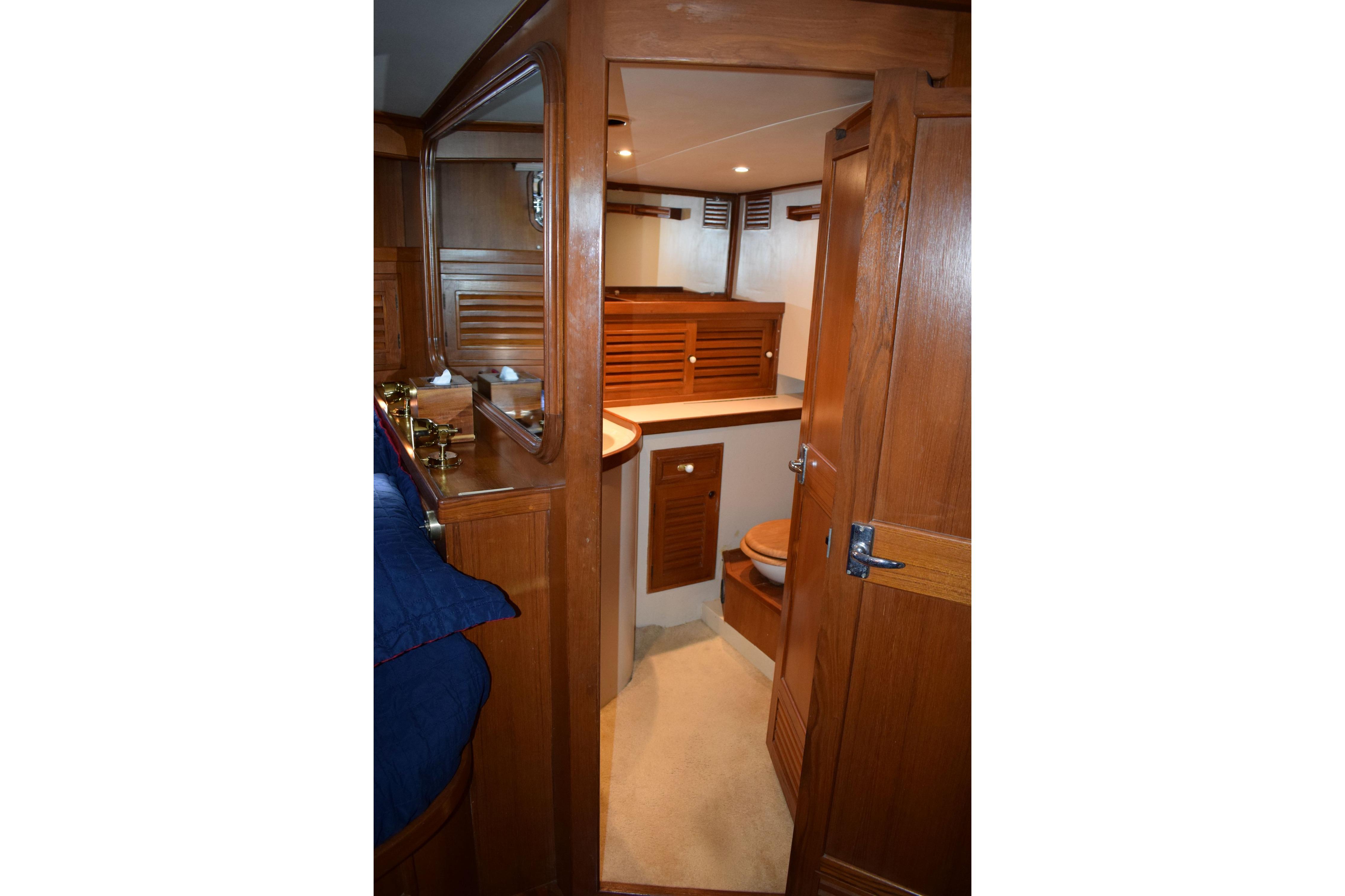 Interior of 1980 Cheoy Lee 52 Motorsailer with wooden cabinetry and cozy design.