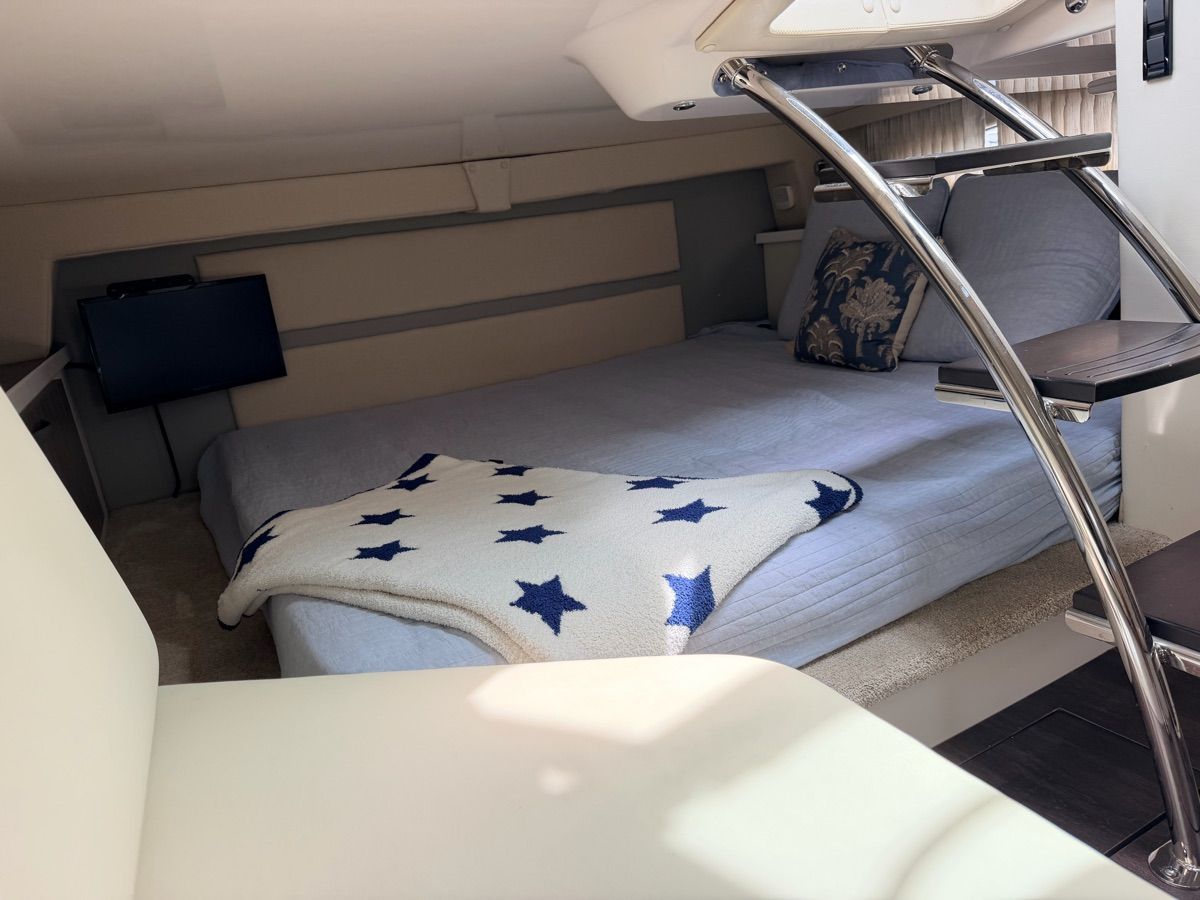 Interior of a 2021 Regal 33 Express with a cozy bed and star-patterned blanket.