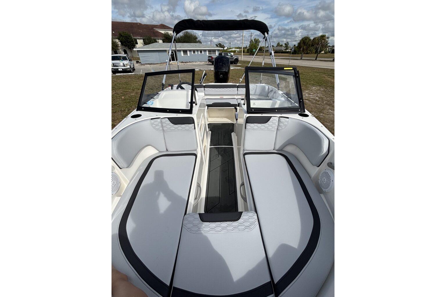 2025 Bayliner Element M17 boat interior with seating and windshield, parked outdoors.