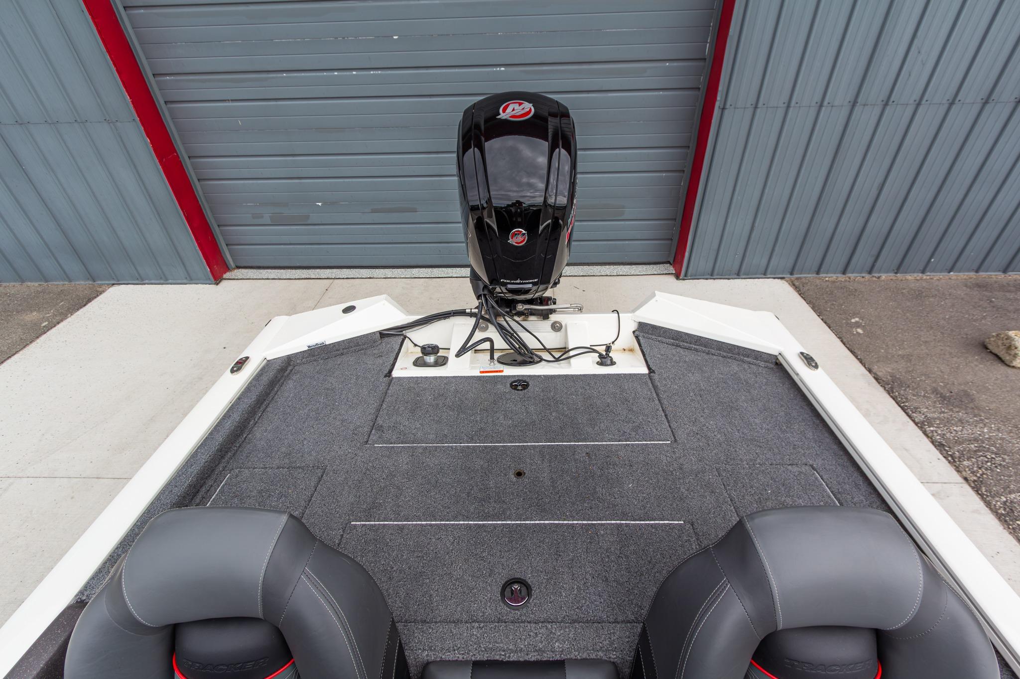 2023 Tracker Pro Team 190 TX boat interior with motor, gray carpet, and seating.