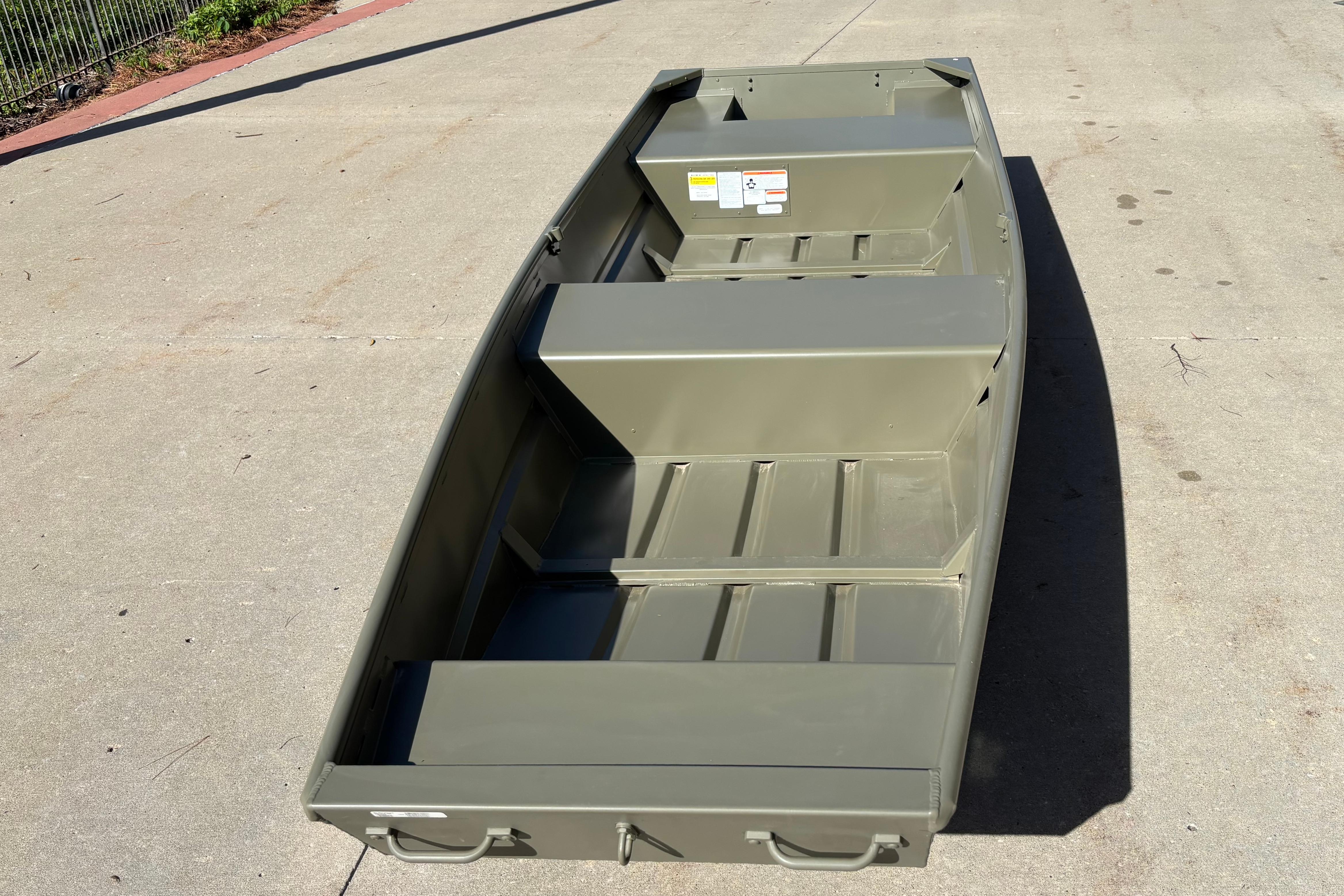 2026 Tracker Grizzly 14 Jon boat on concrete surface, showcasing its sturdy design.