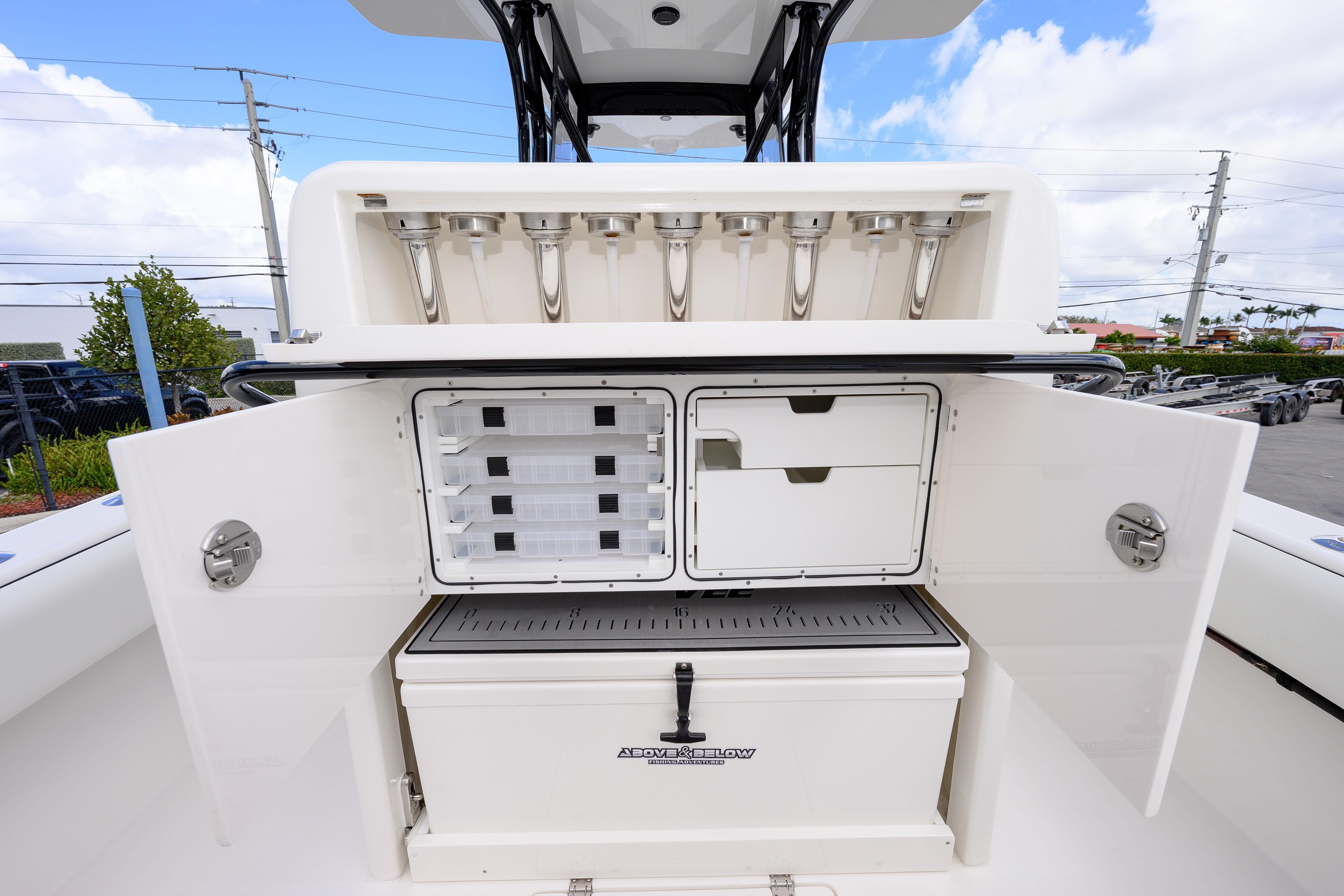 2025 SeaVee 290B boat with open storage compartments and rod holders.