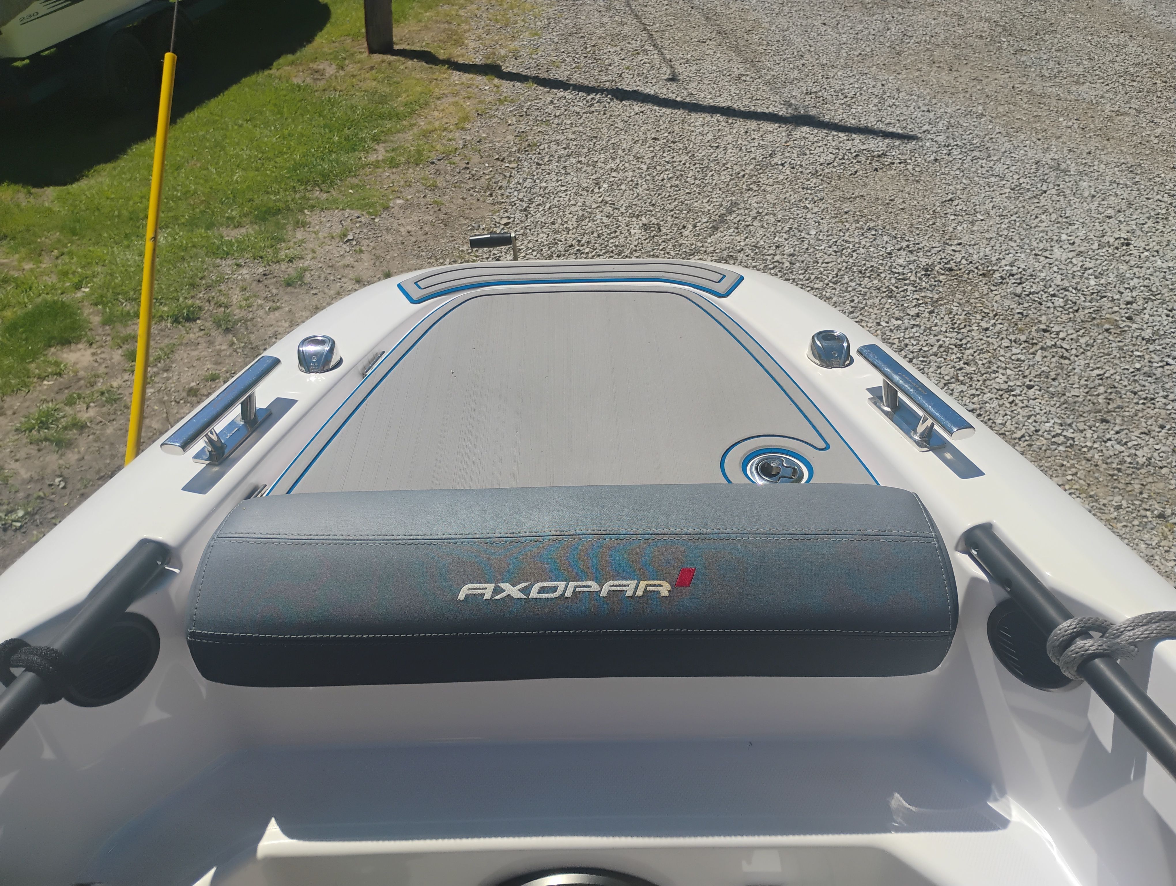 Axopar 22 T-Top 2022 boat, front deck view on gravel path.