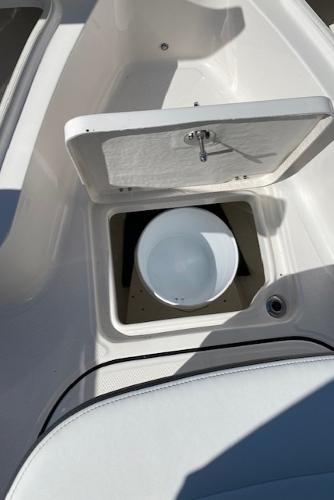 2024 Robalo R222 Center Console storage compartment with white bucket.