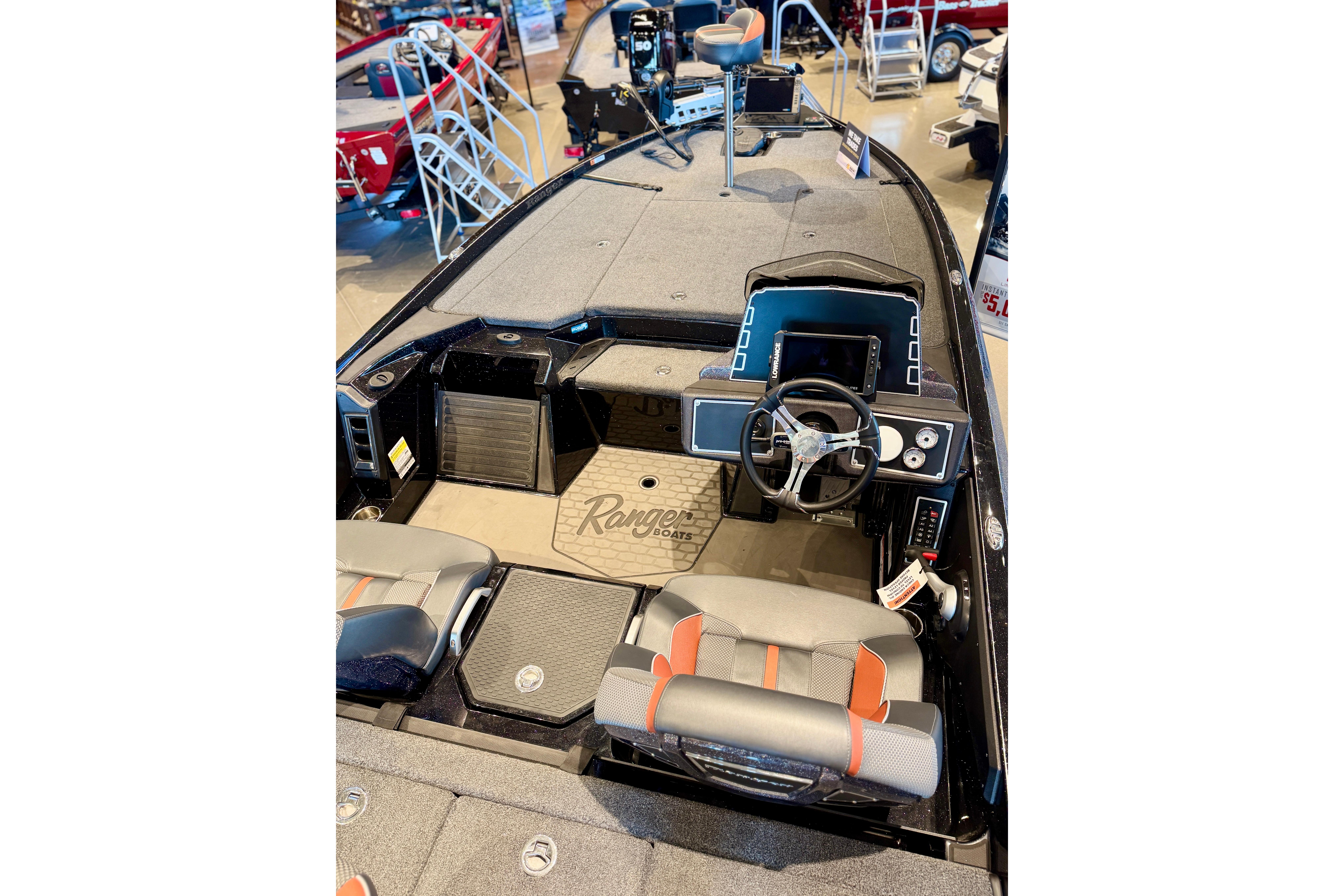 2025 Ranger Z520 boat interior with steering wheel and seating, displayed in showroom.
