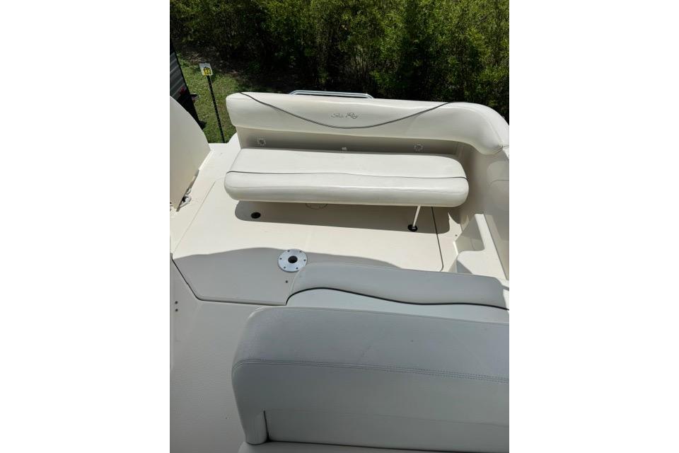 2004 Sea Ray 240 Sundancer boat interior with white seating and open deck area.