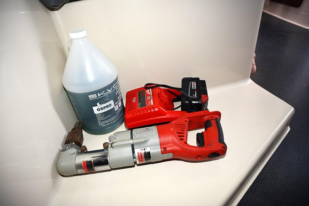 Red power tool and cleaning solution on Fountaine Pajot Athena 38 yacht interior.