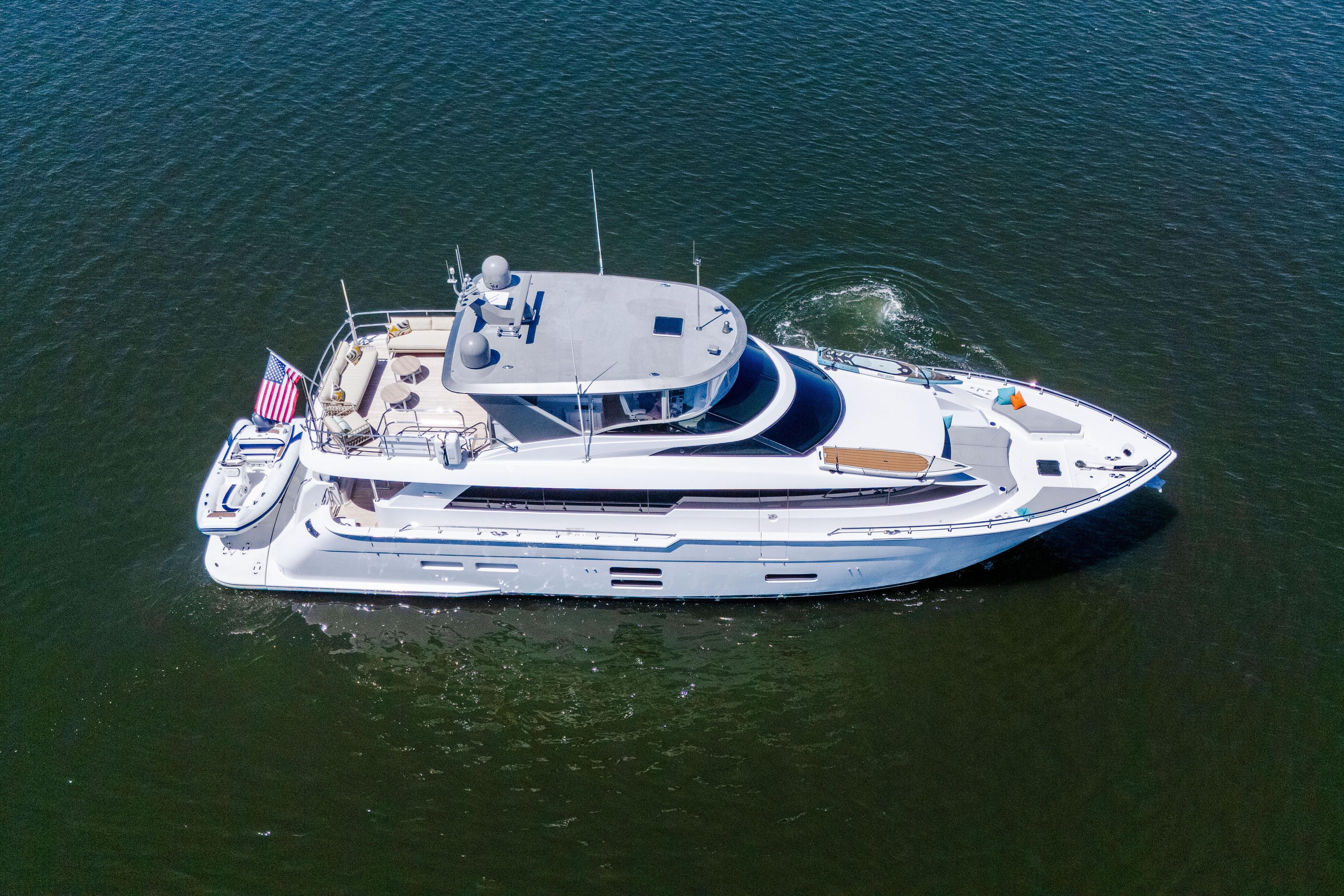 Aerial view of 2021 Hatteras M75 Panacera luxury yacht cruising on open water.