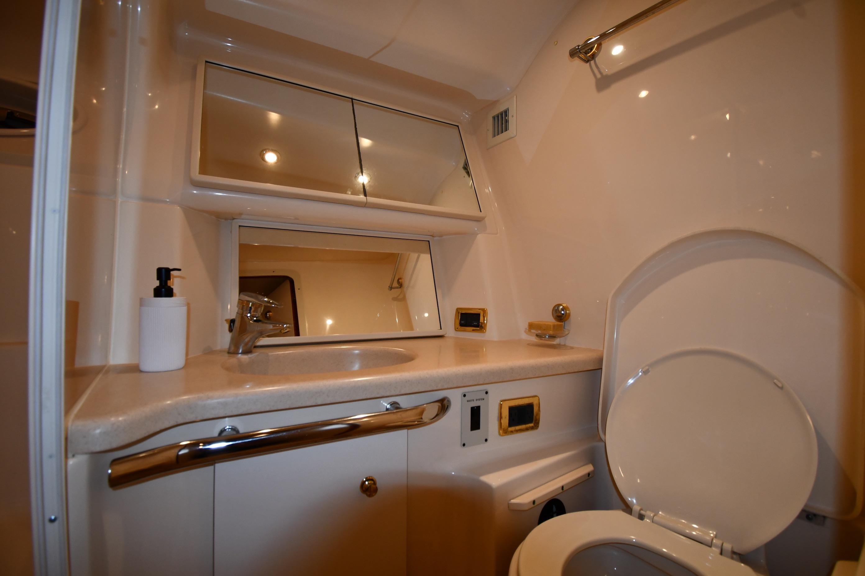 Luxurious bathroom in 2001 Sea Ray 540 Sundancer yacht, featuring modern fixtures and ample lighting.