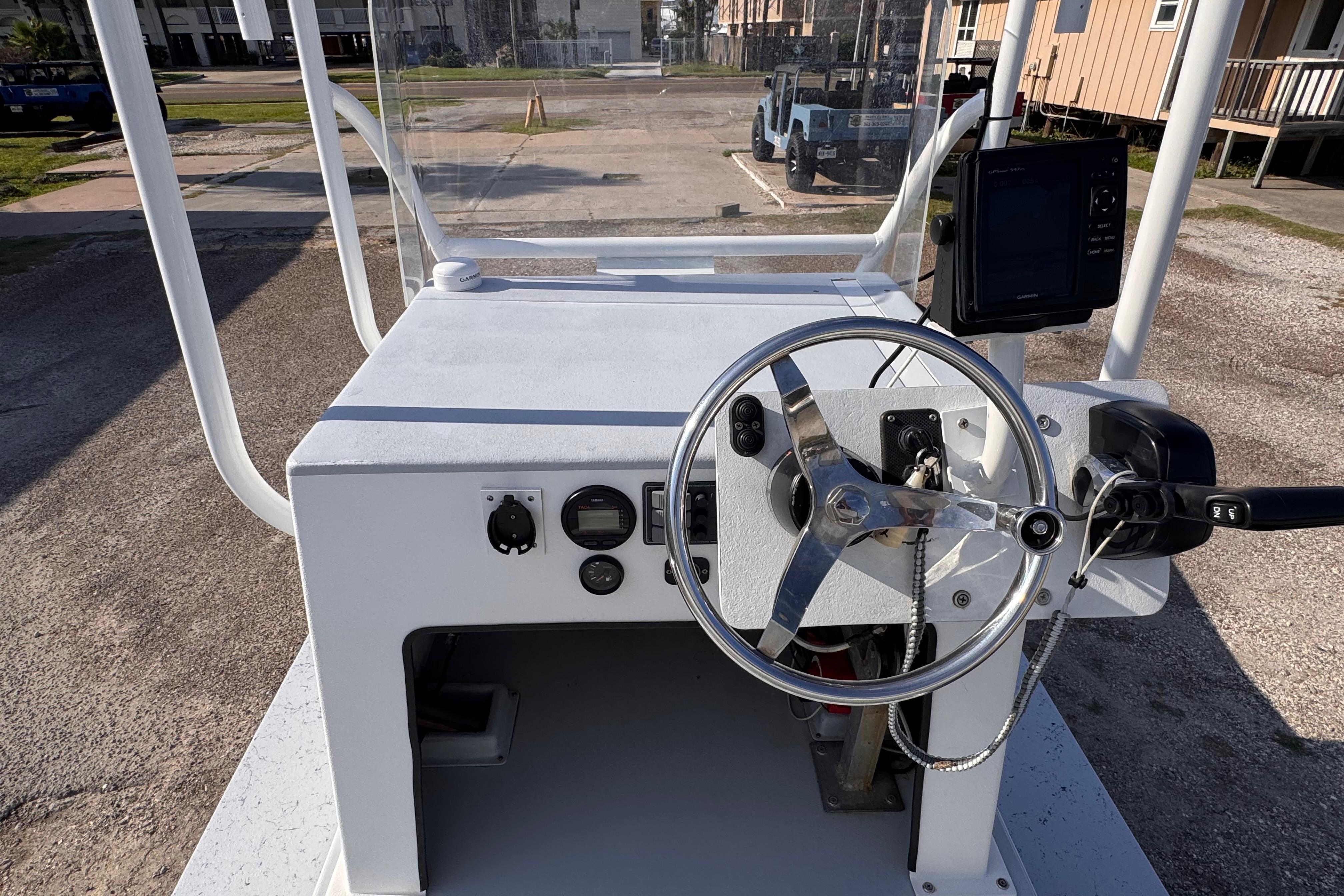 Steering console of a 2006 Waterman K-18 boat with navigation equipment.