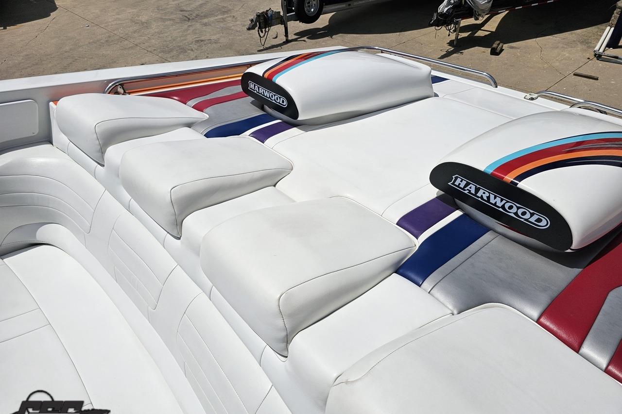 2002 Formula 382 FASTech boat interior with white upholstery and colorful accents.