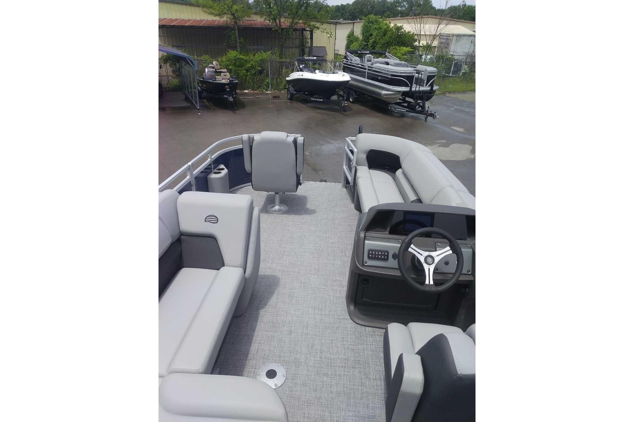 2026 Sun Tracker SportFish 20 DLX pontoon boat interior with seating and steering console.