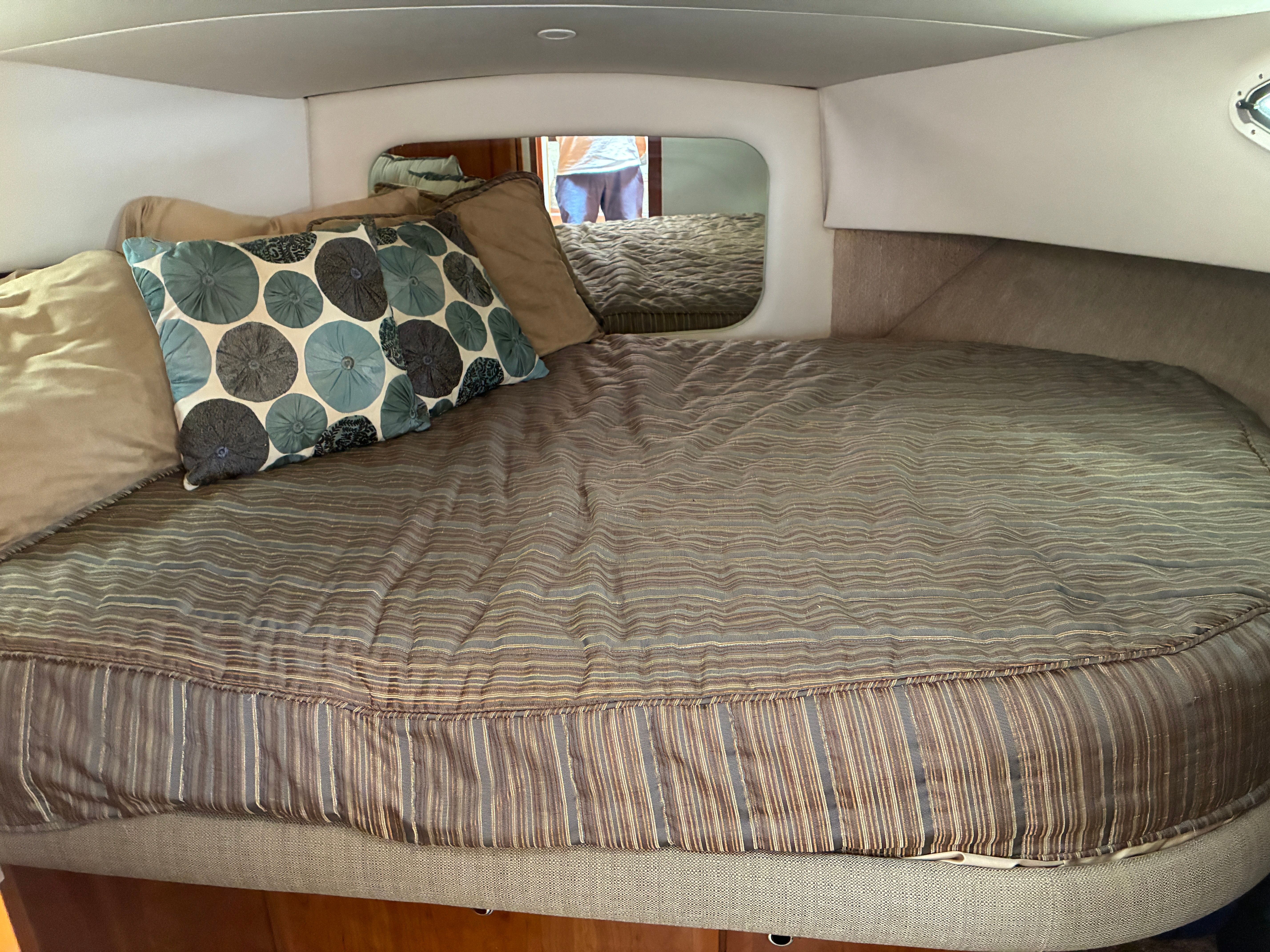 Interior of the 2001 Silverton 392 Motor Yacht featuring a cozy bed with pillows.