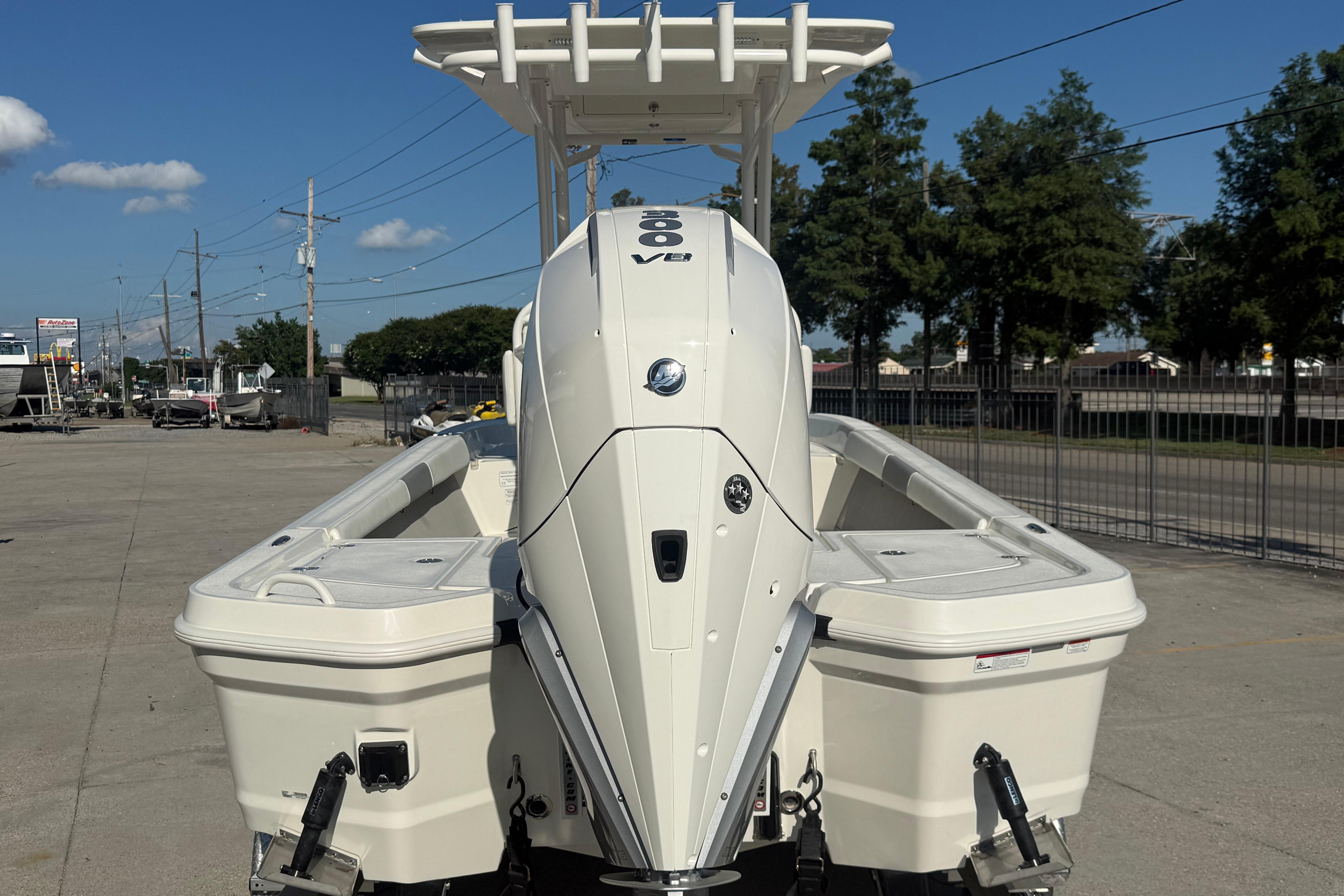 2026 Mako 24 APEX boat with powerful outboard engine, parked outdoors.